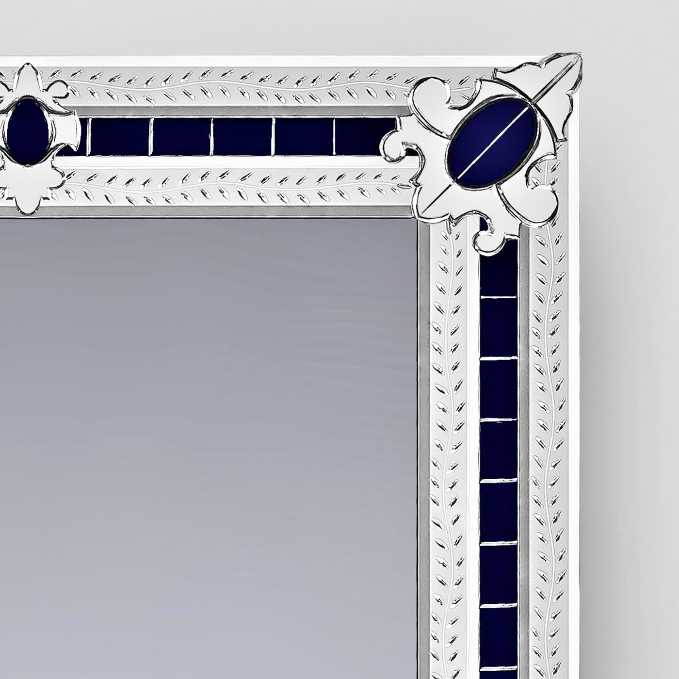 Magnificent rectangular mirror composed of beveled and silvered mirror embroideries in the corners, all handmade with bands engraved with a floral subject, on a blue Murano glass mirror background. This miniature reproduction of a larger mirror is