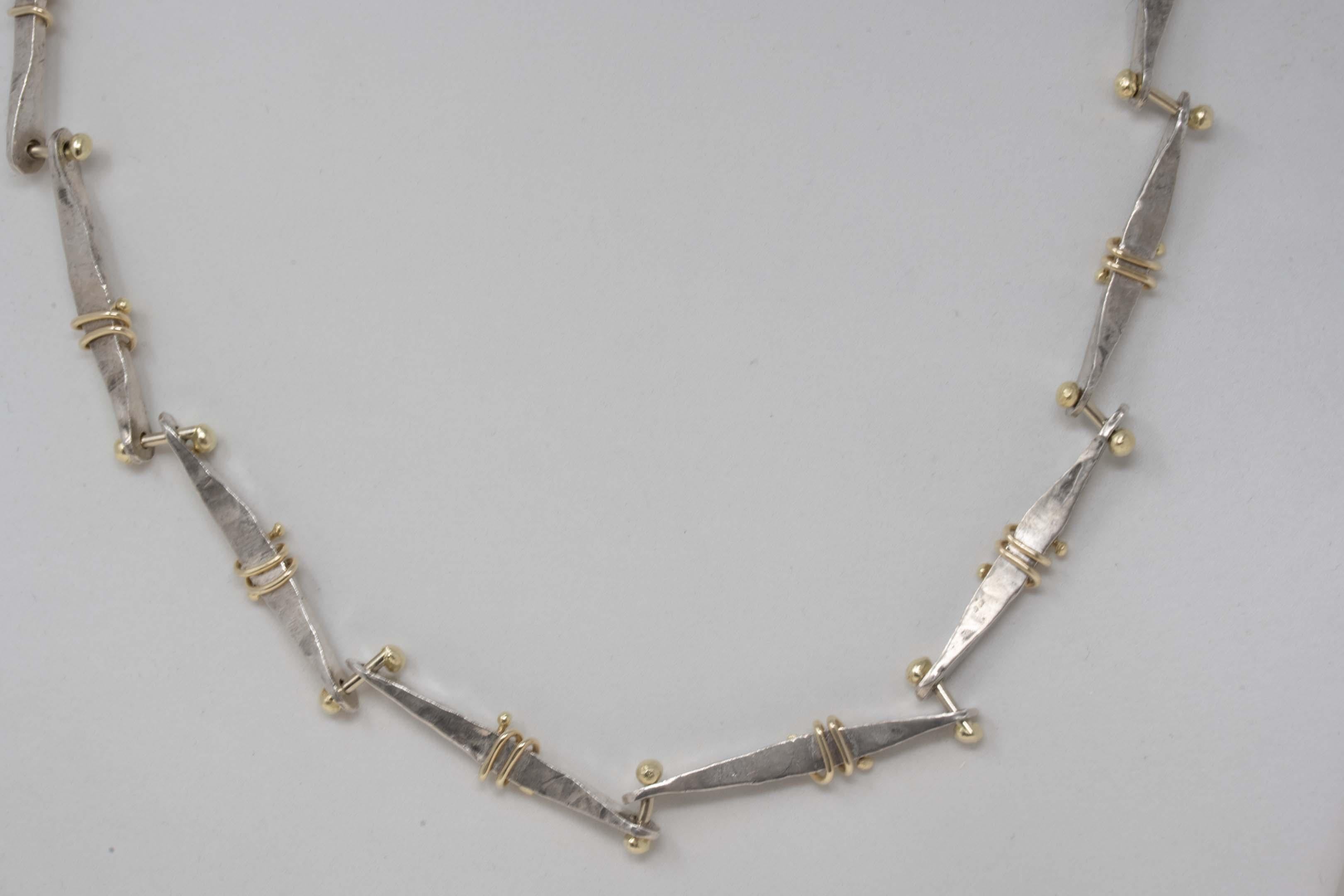 Sana Doumet twirly bone necklace set sterling silver & 18k gold chain. The chain measures 16 1/2 inches long x 0.25 inches wide. Earrings measure 1.75 inches long, fully marked Sana M.D. sterling, 18k. Made in the USA, circa 21st century.