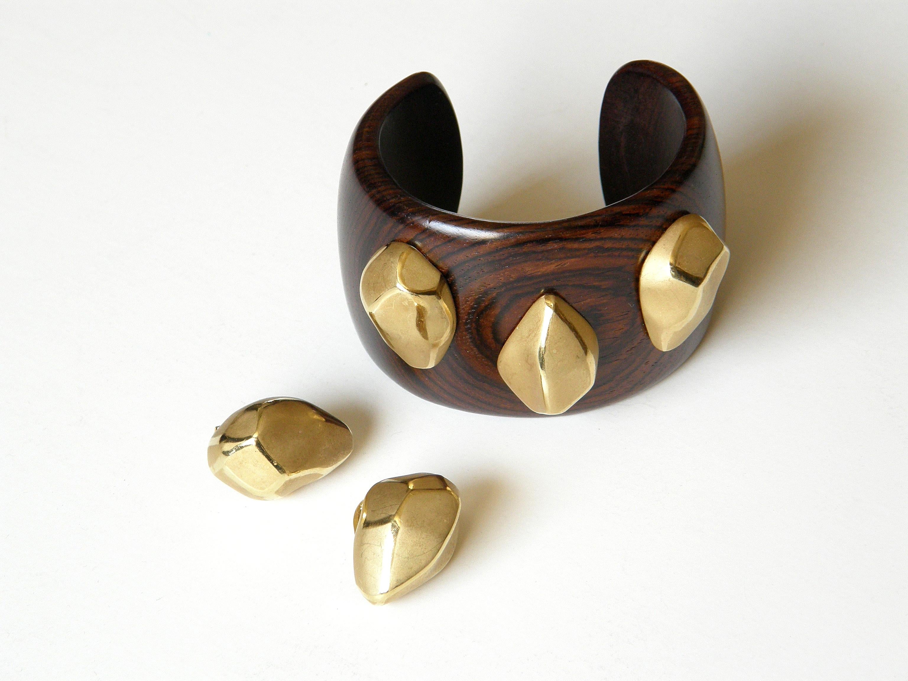 This 18k gold and wood cuff bracelet and clip-on earrings set was designed and made in Italy by Massimo Sanalitro. His bold and modern design features softly faceted, yellow gold “stones” as earrings and embellishments on the bracelet. They have a