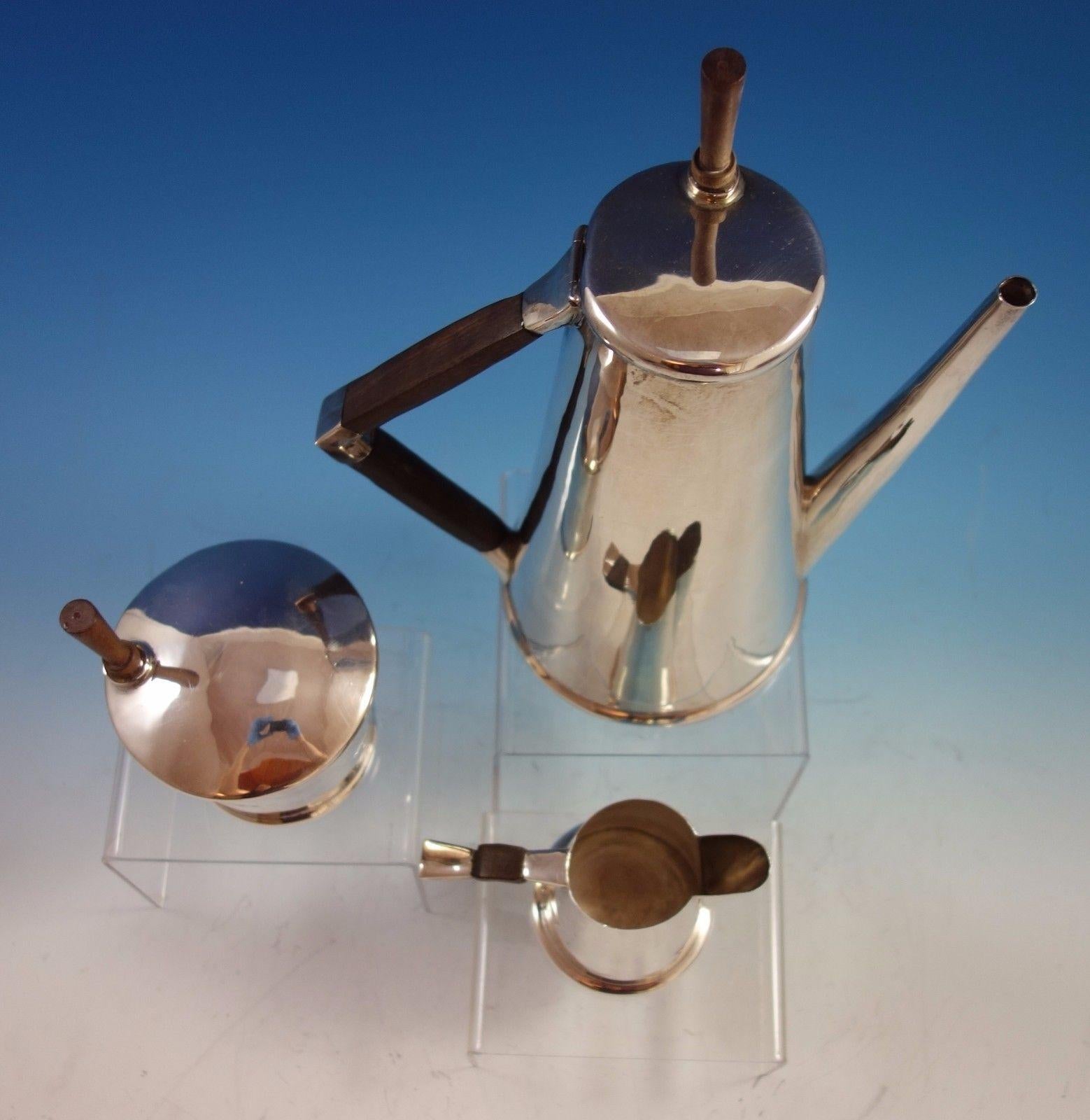 Modernist Mexican sterling silver 3-piece coffee set made by Sanborns with rosewood accents. The pieces are marked with #7015. The set includes: 
1 - Coffee Pot: Weighs 25.7 ozt., and measures 11 1/4