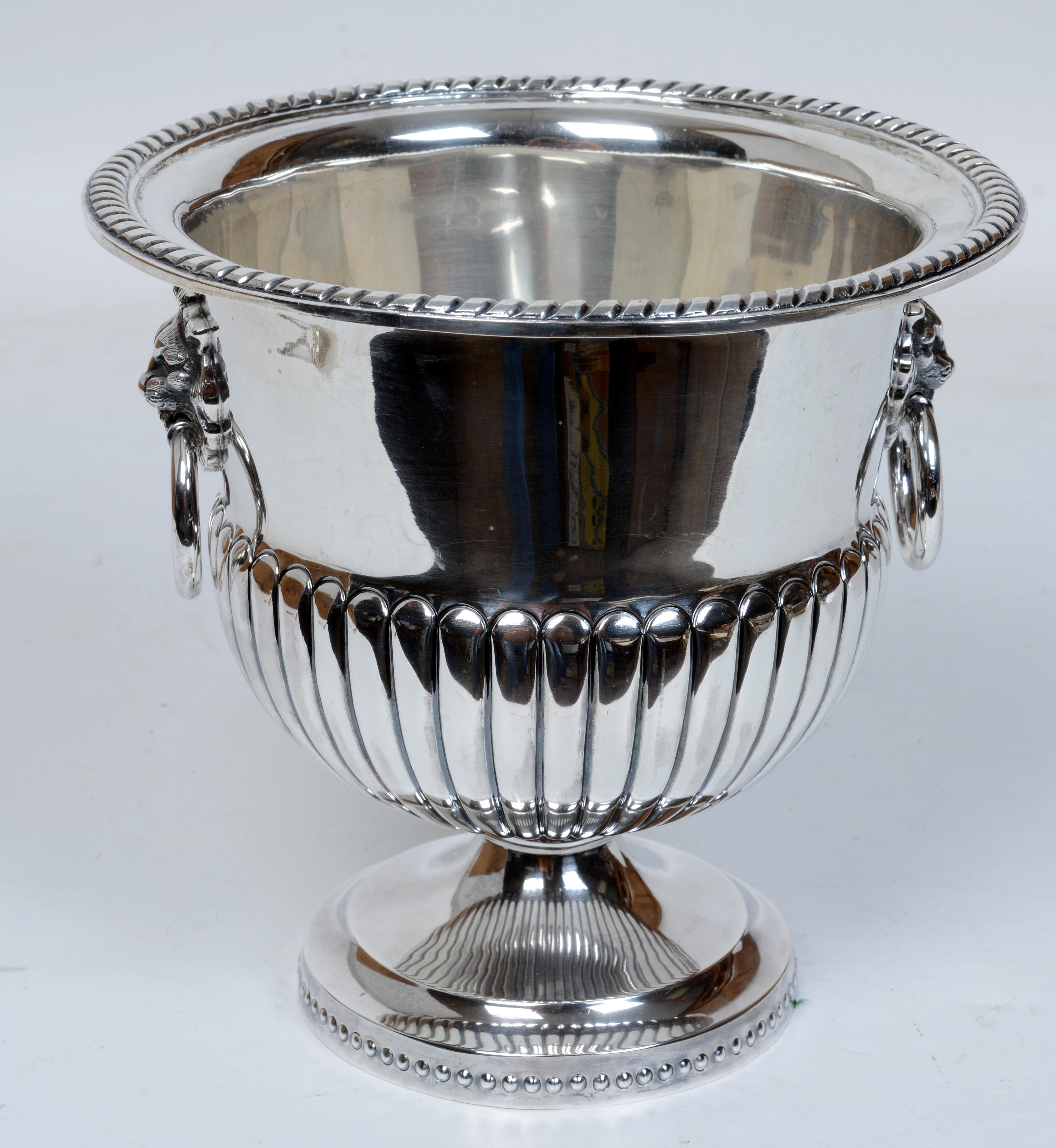 Sanborns, Mexico, Regency Style Sterling Silver Wine Cooler With Lions Head Handles. The sides with ribbed gadrooning, raised on conical base with beaded border. 61.5 penny weight. 
Trent Antiques has been a respected name in antiques for over 35