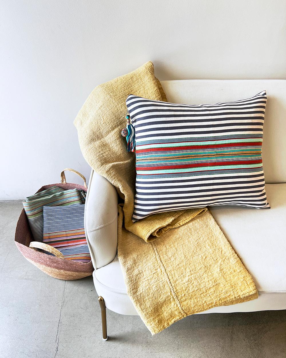 This SanCri Pillow is the perfect combination of modern and traditional. The striped pattern featuring red, green, and gray hues adds a pop of color to any room. Crafted from 100% cotton, this pillow is designed with a classic Latin American look