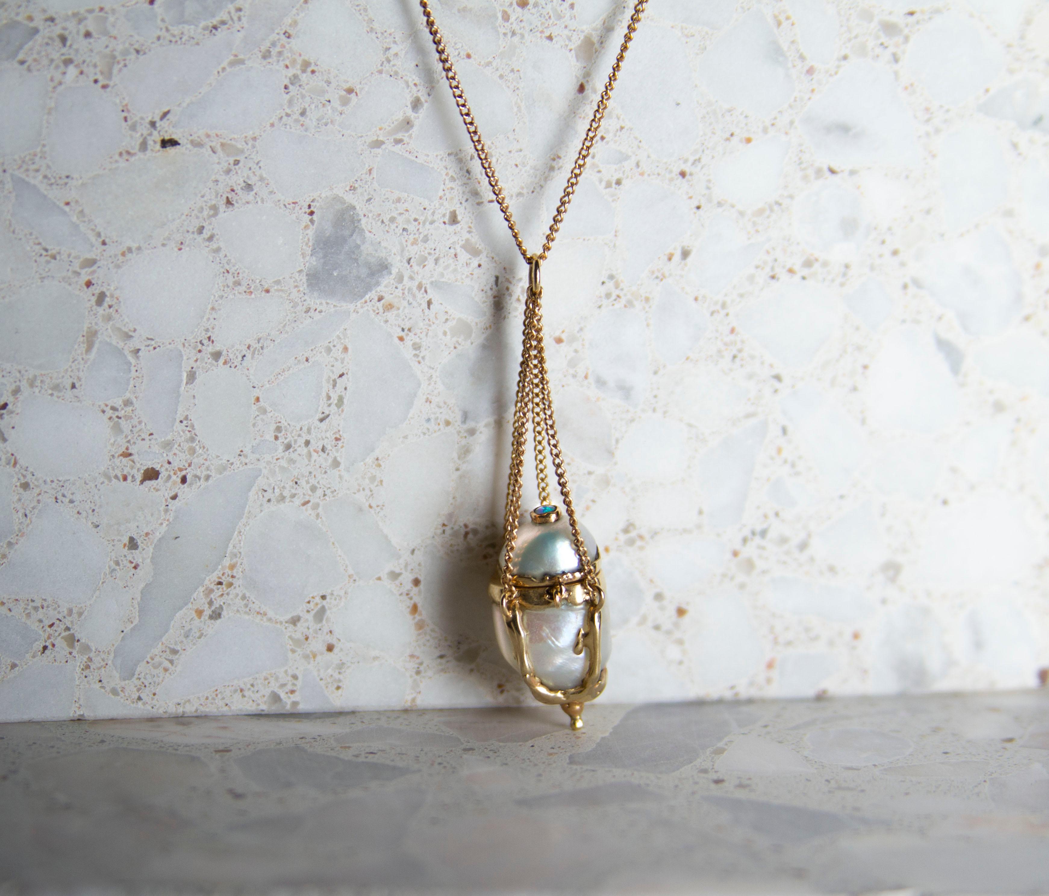 Pearl miniature vessel Necklace in 14k Gold.

Designed and created by Julia de Souzain New York.

Julia de Souza is a Brazilian- Costa Rican Jewelry Designer based in NYC.  Her designs are inspired by little stories, music, and mythological