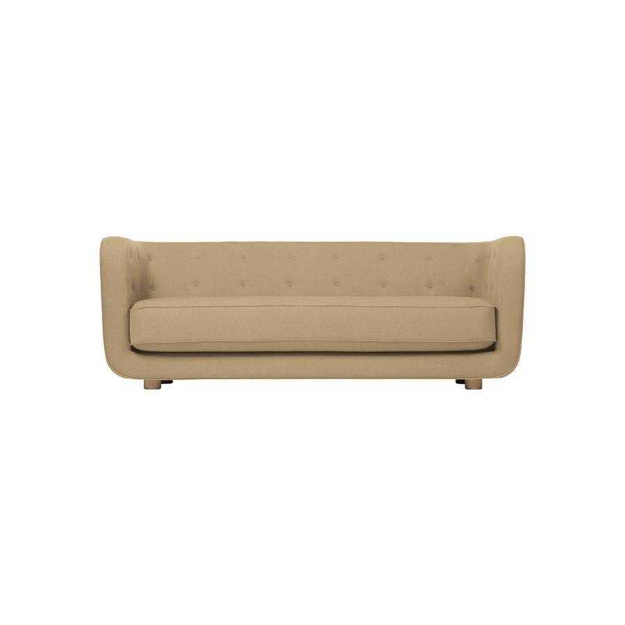 Sand and smoked Oak Raf Simons Vidar 3 Vilhelm sofa by Lassen
Dimensions: W 217 x D 88 x H 80 cm 
Materials: Textile, Oak.

Vilhelm is a beautiful padded 3-seater sofa designed by Flemming Lassen in 1935. A sofa must be able to function in