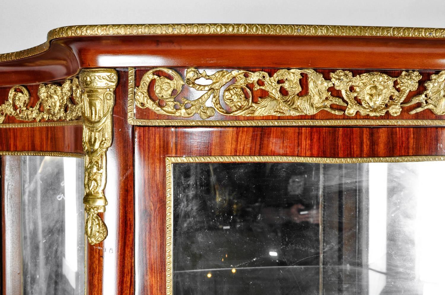 Sand burl wood mahogany hutch cabinet / vitrine with mirrored interior and Bronze mounted design details. The hutch cabinet / vitrine is in excellent antique condition. Minor wear consistent with age / use . The piece measure 64 inches high x 36