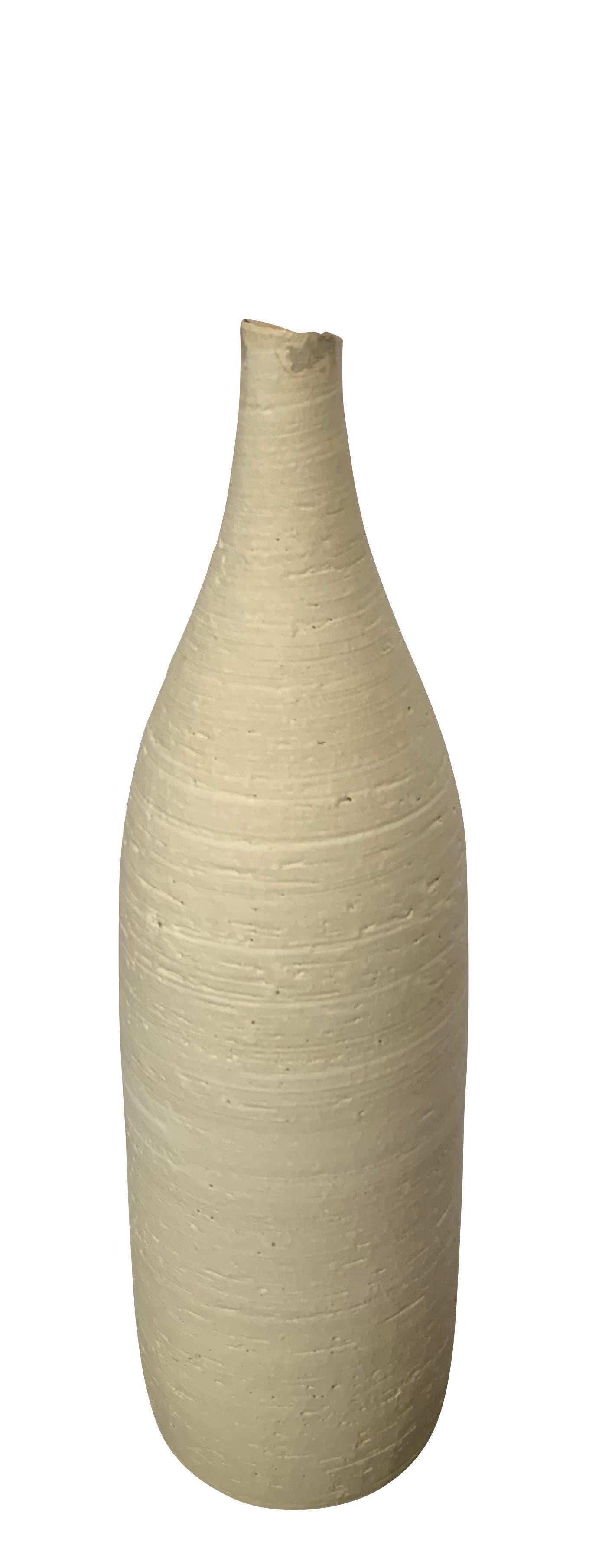 Contemporary German handmade stoneware vase.
Sand color.
Textured with small lip opening.
Part of a large collection of handmade vases of different sizes , shapes and textures.