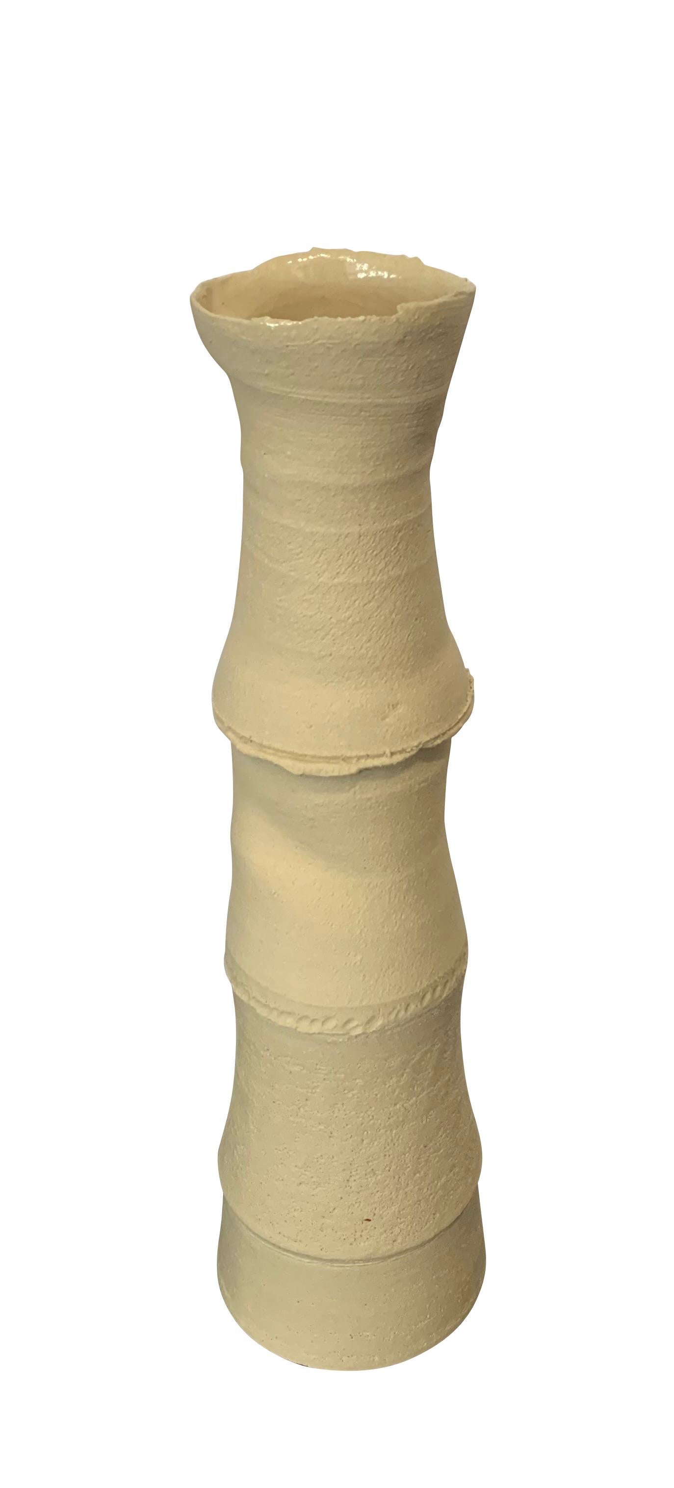 Contemporary German handmade stoneware vase.
Vertebrae design.
Sand color stoneware.
Small lip opening.
Part of a large collection of handmade vases of different sizes , shapes and textures.