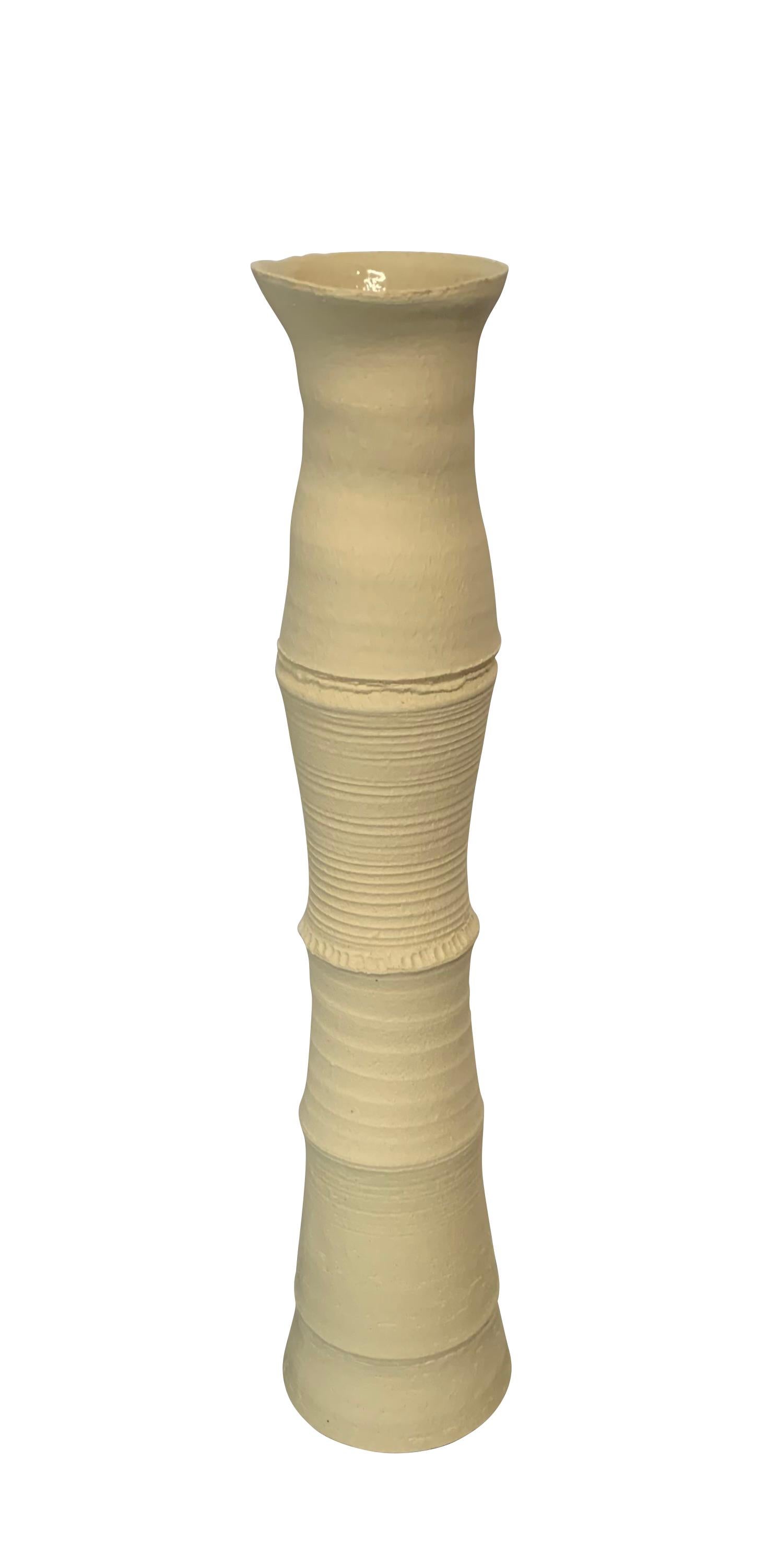 Contemporary German handmade stoneware vase.
Vertebrae design.
Sand color stoneware.
Part of a large collection of handmade vases of different sizes , shapes and textures.