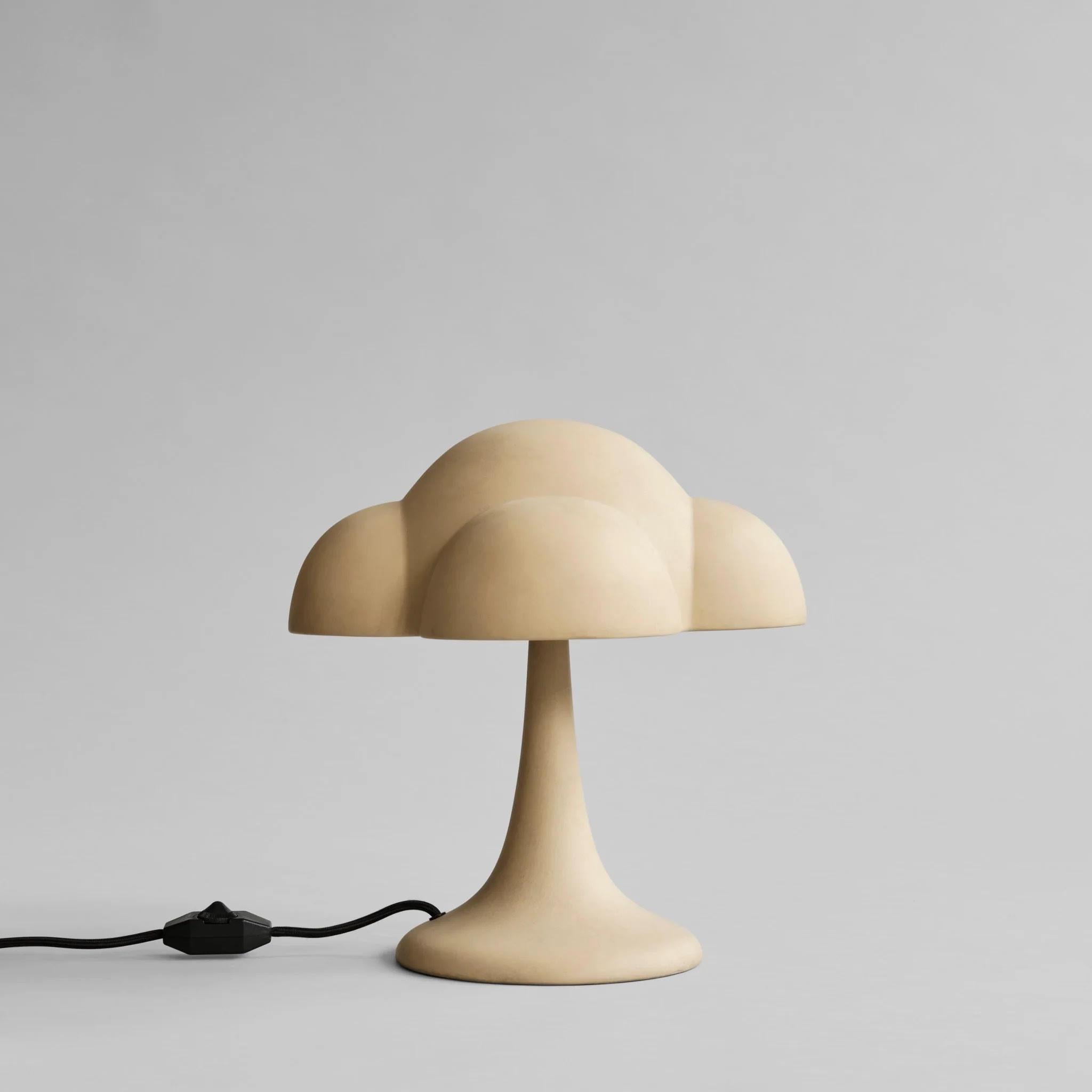 Sand-coloured table lamp, ceramic, contemporary work.

This table lamp is inspired by 70s design. It comes with a ceramic shade placed on a metal frame, mounted on a cone-shaped lamp base. 
Everything except the metal frame is ceramic. As this is a