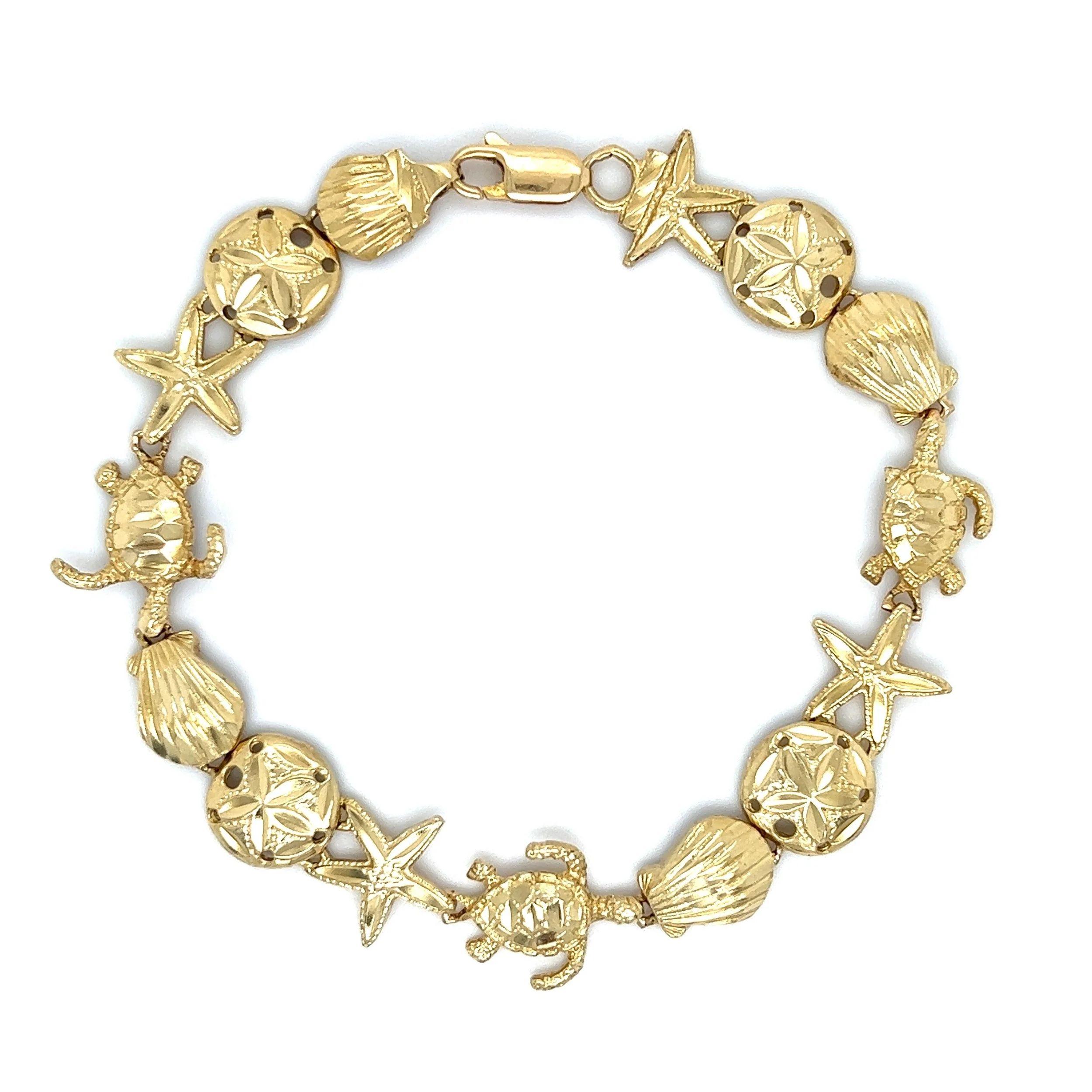 Simply Beautiful! Featuring Sea Life, Starfish, Sand Dollar Seashell and Turtle Gold Link Bracelet. Hand crafted in 14K Yellow Gold. Measuring approx. 7.5