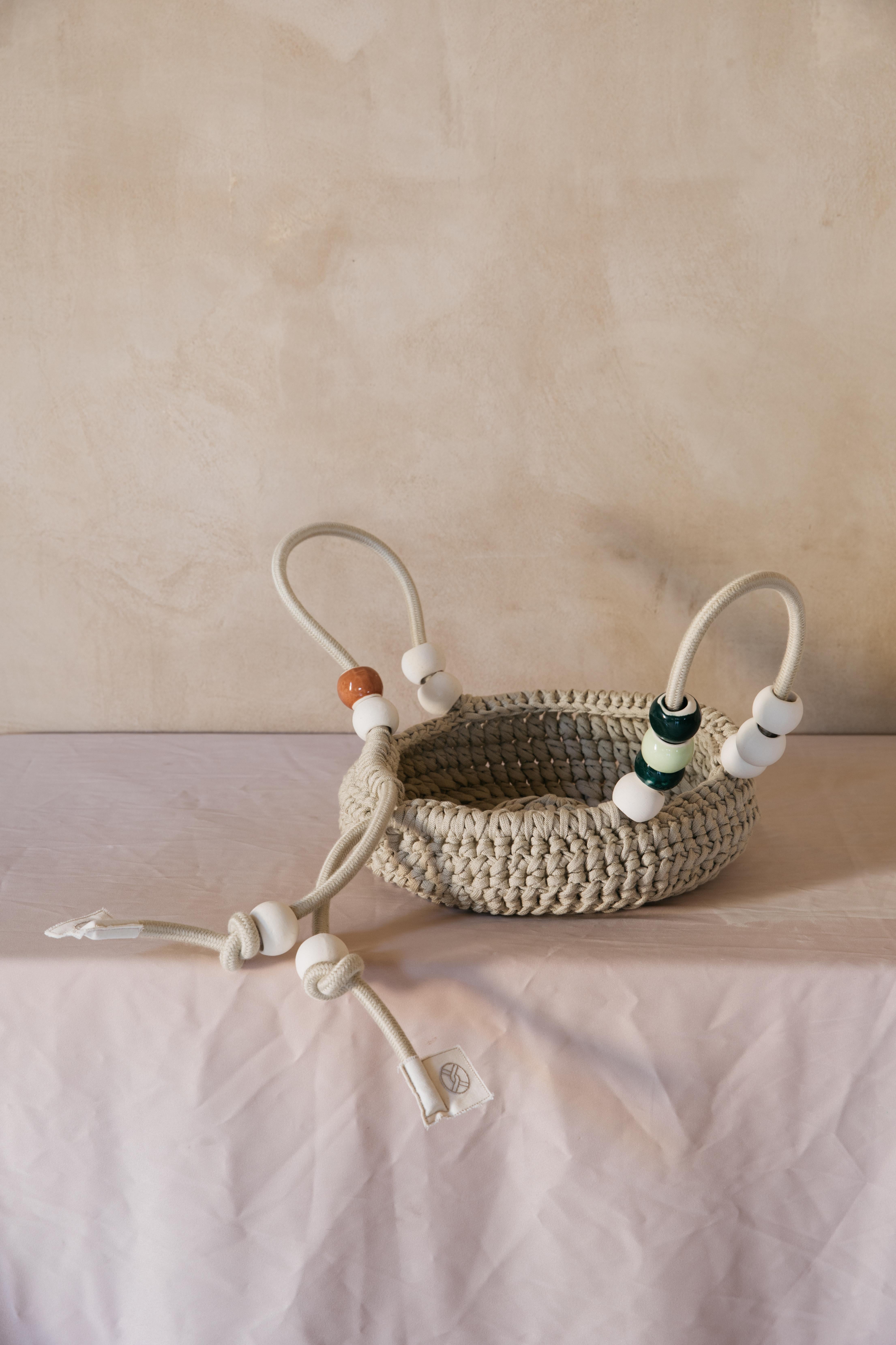 Iota X Abs Objects - Large basket

Crochet basket with rope handle and stoneware beads.
Our collaboration was born early March 2020. While trying to figure out life in the shade of Covid-19, our thoughts wandered out to picnics moments, traveling