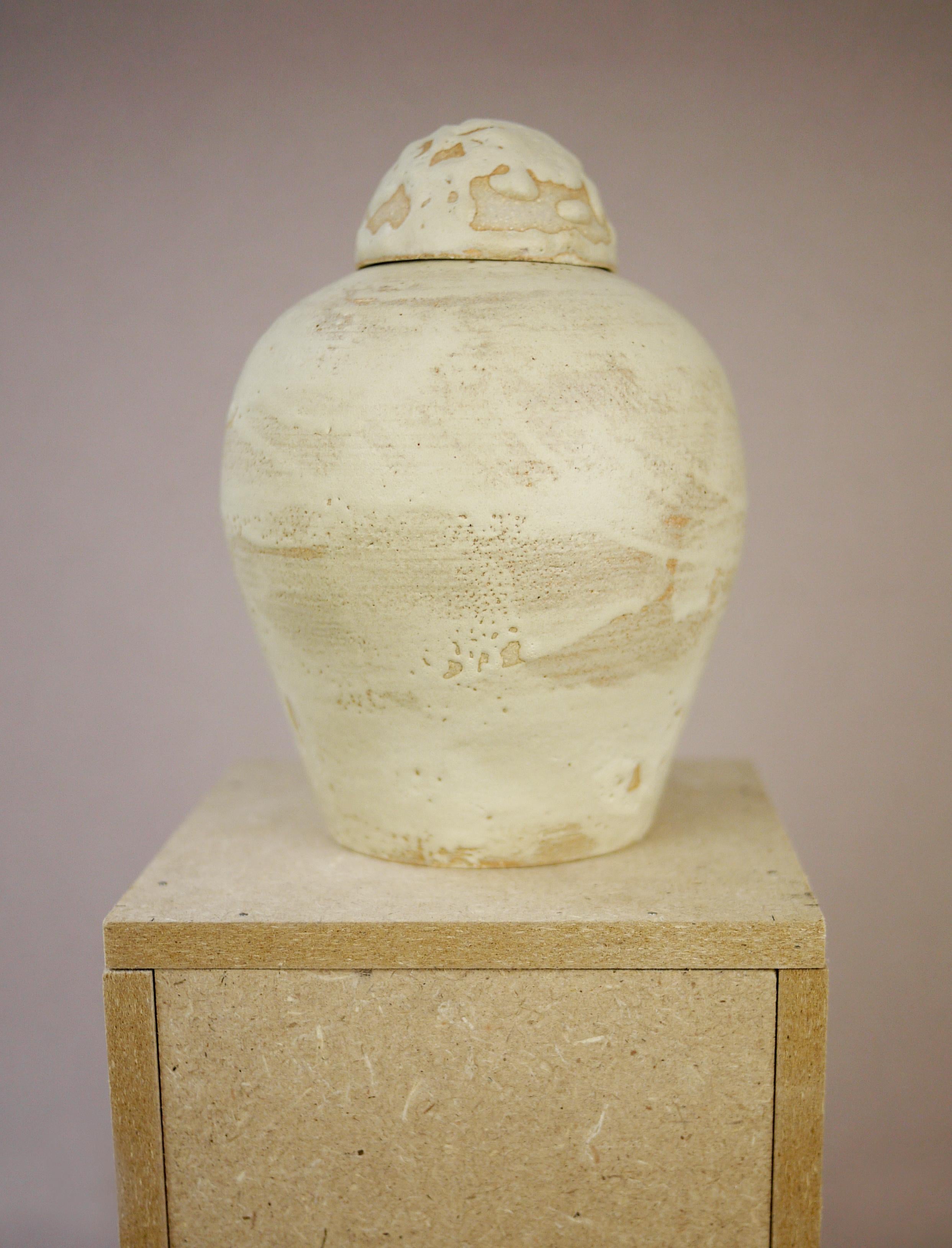 Inspired by the centenary of Tutankhamun tomb discovery, this lidded vase is a nod to Ancient Egypt canopic jars.
White stoneware and matt sand colored matt glaze.
2022

///
Juliette Teste 
French, 1986, lives and works in Paris, France.
Teste’s