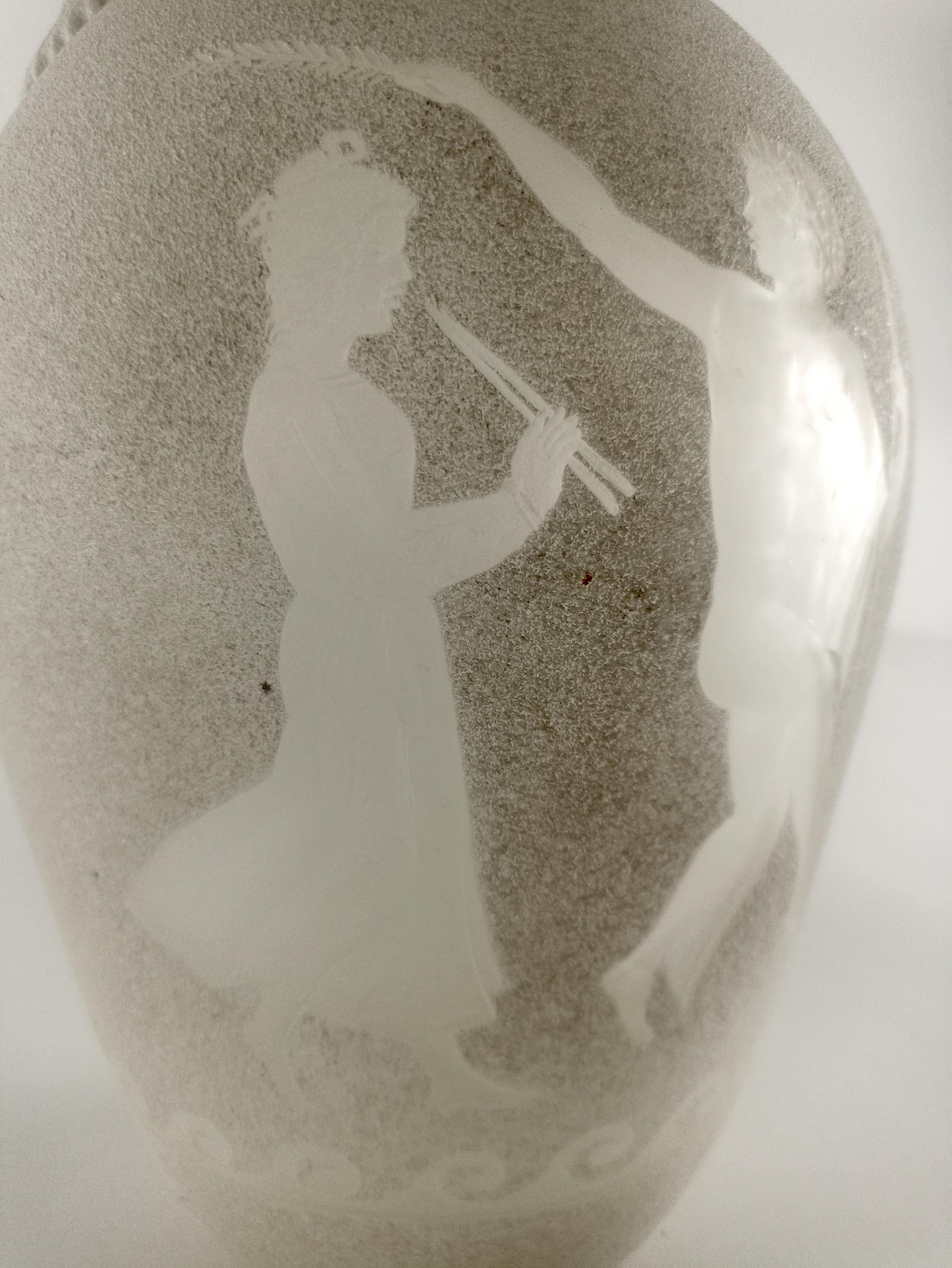 Die exquisite Vase aus sandgestrahltem Murano-Glas - eine der traditionellsten Techniken der Kaltbearbeitung von Murano-Glas - wertet Ihre Einrichtung auf. Diese elegante und klassische Vase zeigt auf der Vorderseite ein wunderschön eingraviertes