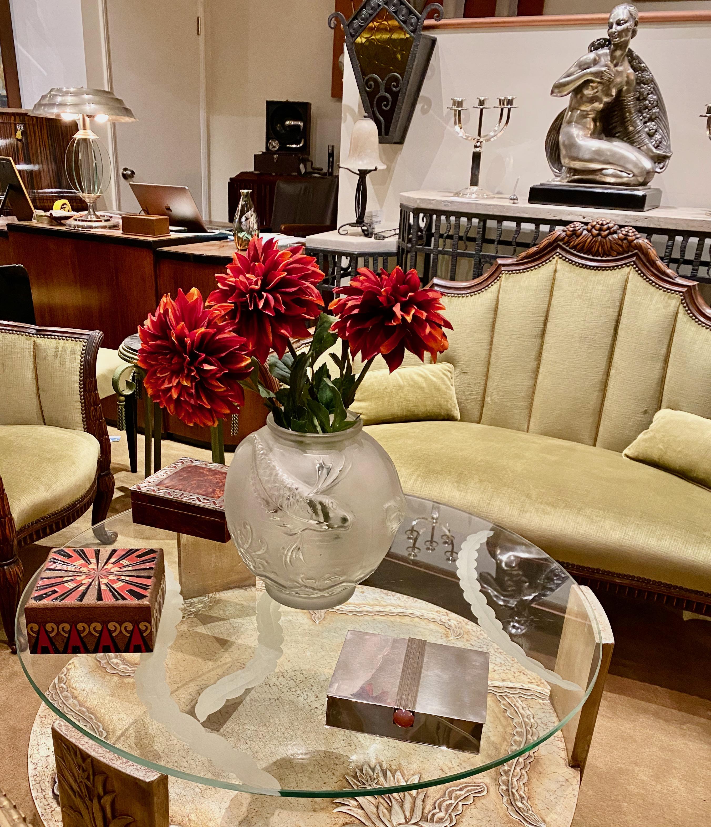 Sandblasted glass top Art Deco coffee table with silvered wood base. Stunning 3-D table design with floral impressions of leaves and flowers. Deep etched thick glass top, sits firmly on this wonderful silver-leafed table. Nice size round coffee