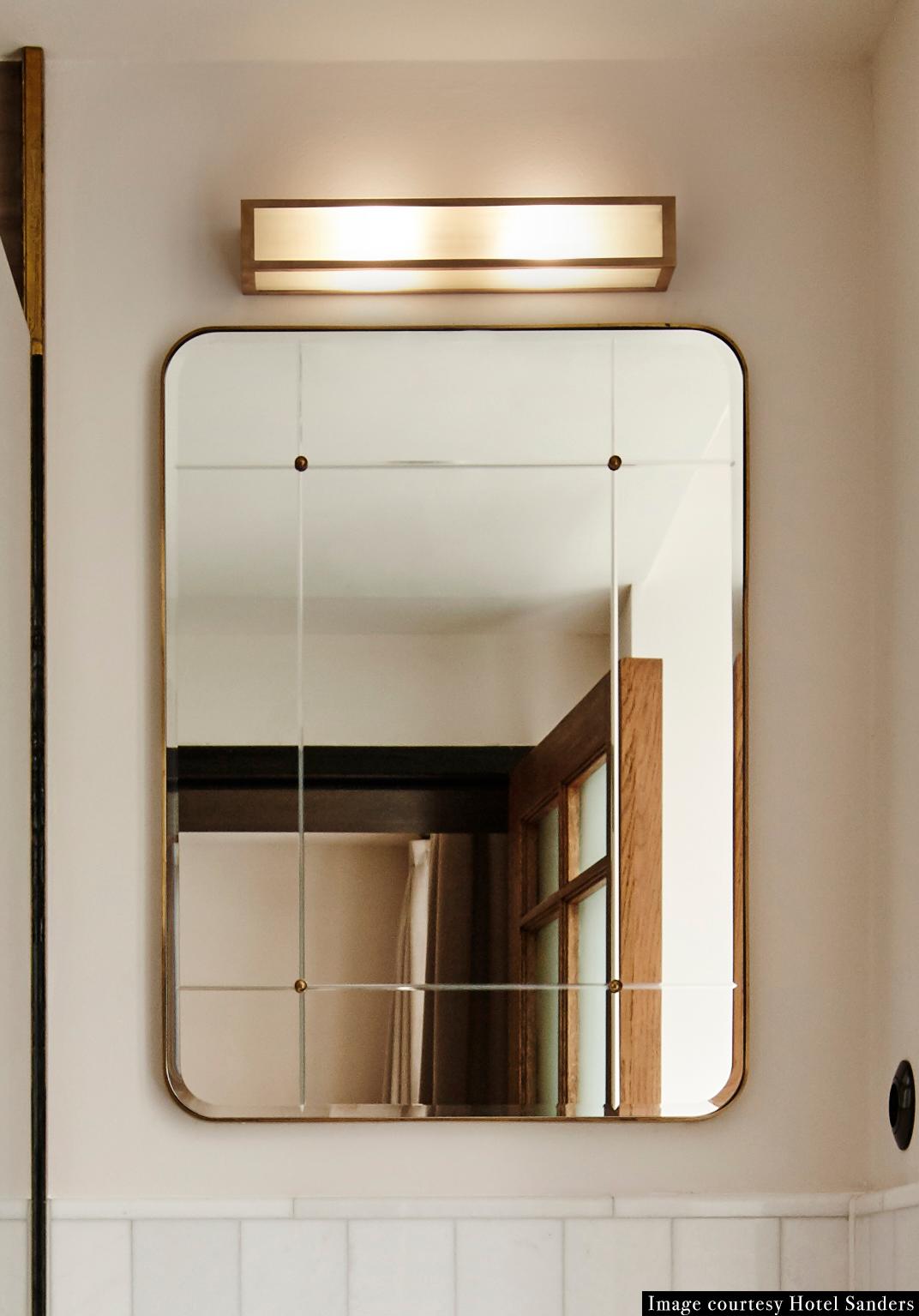 Bathroom mirror for Sanders by Lind + Almond in cut glass and brass, large a mirror in cut-glass and hand patinated brass, with brass studs. Developed especially for Sanders, Copenhagen's premier luxury boutique hotel.

Available in two sizes.