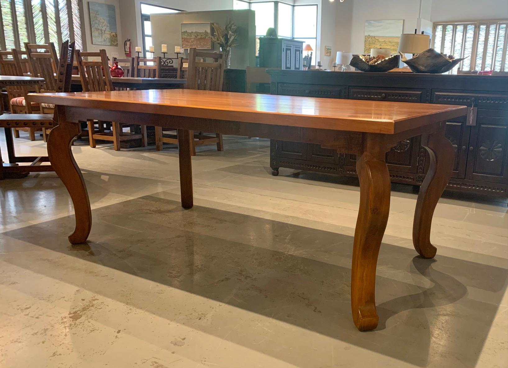 Beautiful Ernest Thompson Sandia Dining Table. 
Hand carved legs with a custom finish.

This is a showroom table so does show some use.
