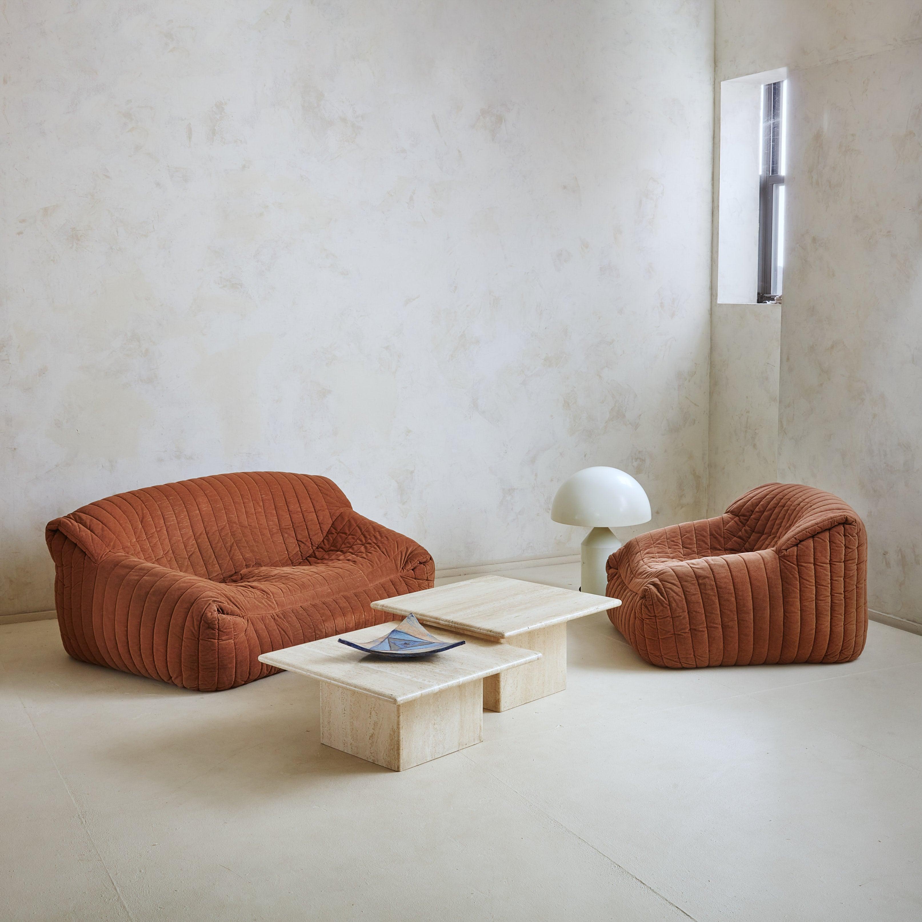 An iconic 1970s ‘Sandra’ channeled lounge chair designed by Annie Hiéronimus for Cinna after she joined the Roset Bureau d'Etudes in 1976. Constructed from foam, this chair has a solid, sculptural form that is fully upholstered in warm, caramel hued