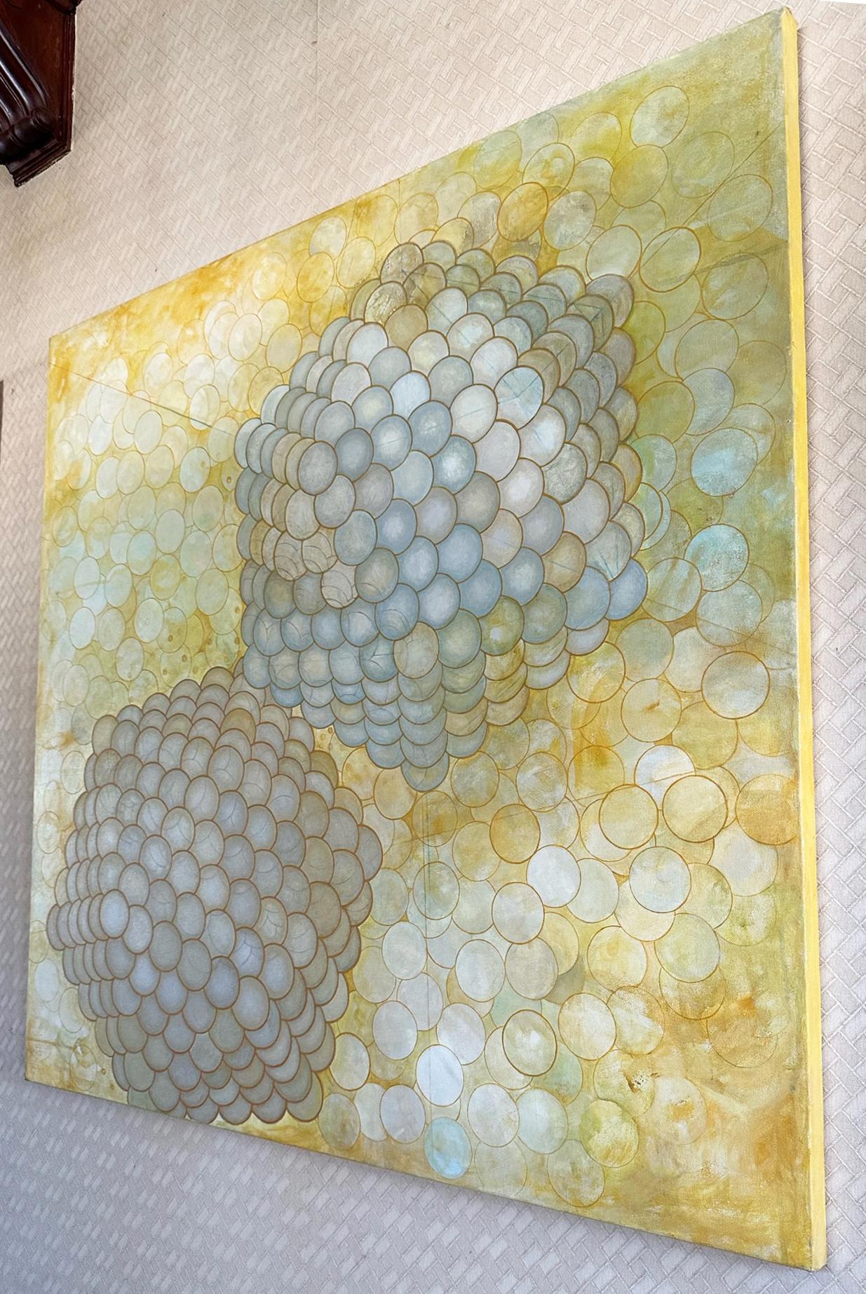 Sandra Cohen’s “I wanna luv ya” is a 48 x 48 x 1 inch abstract acrylic painting on canvas, in yellow, grey, and white. Two virus molecules gravitate towards each other through a dense magnified field, in hopes of reproducing (possibly with make-out