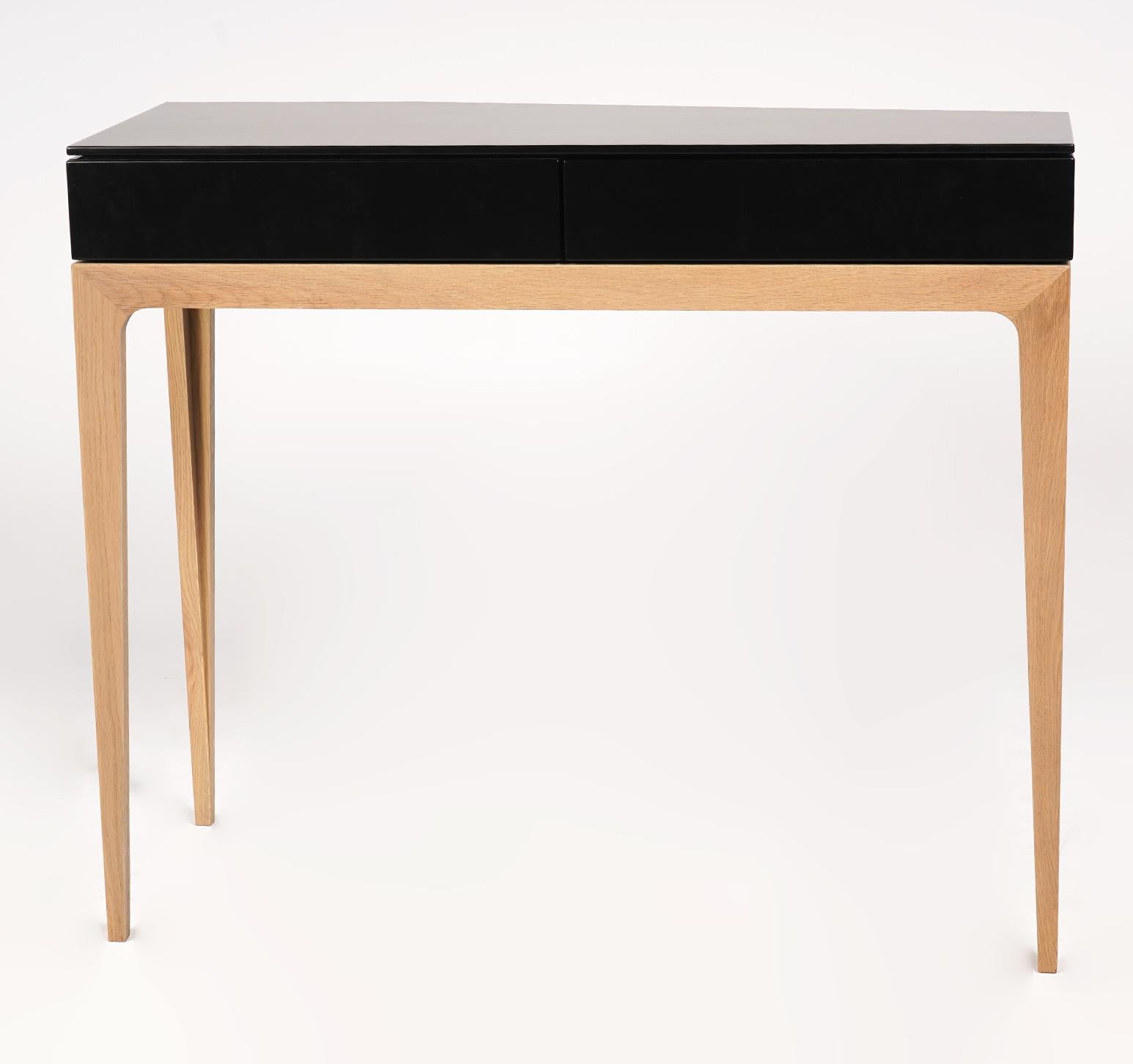 'Moved' console table by Sandra Dumuth for Roche Bobois. Offset design with three legs. Asymetrical three-legged console, top with 2 drawers. Description from Roche Bobois website: Freely designed by young designer Sandra Demuth, the pieces of the