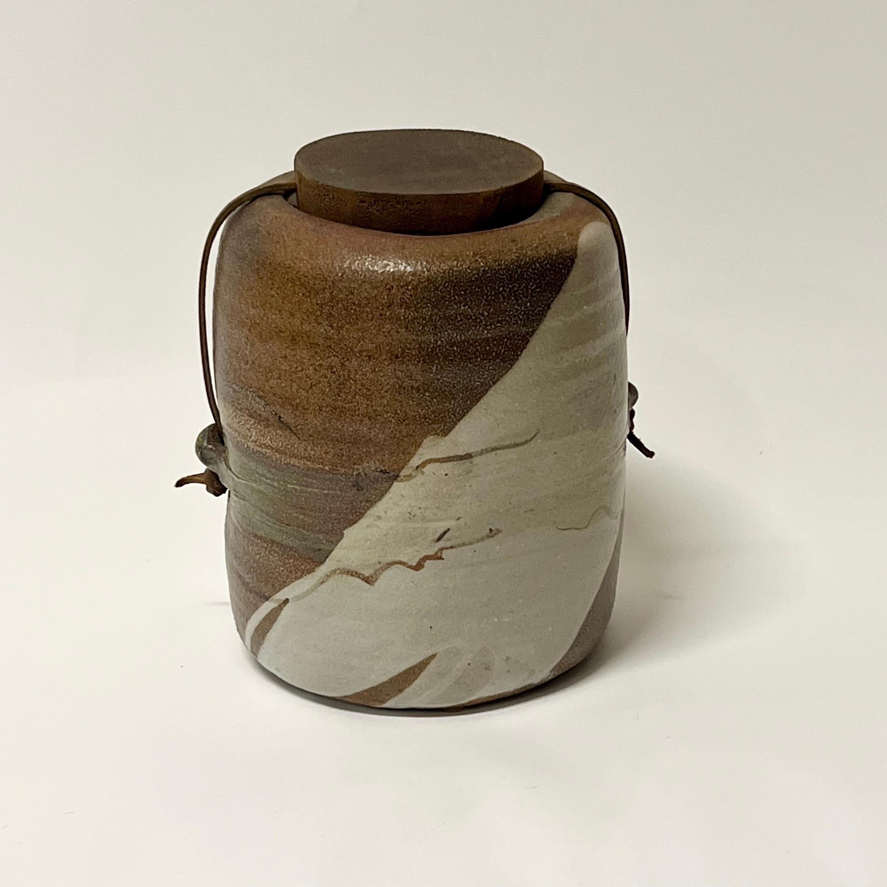 Amazing salt-fired lidded vessel by well listed potter, Sandra Johnstone circa 1970s. Johnstone (1936-1991) studied with Peter Voulkos at UC Berkeley in the 1950s. In addition Johnstone also studied with Paul Soldner. She eventually went on to build