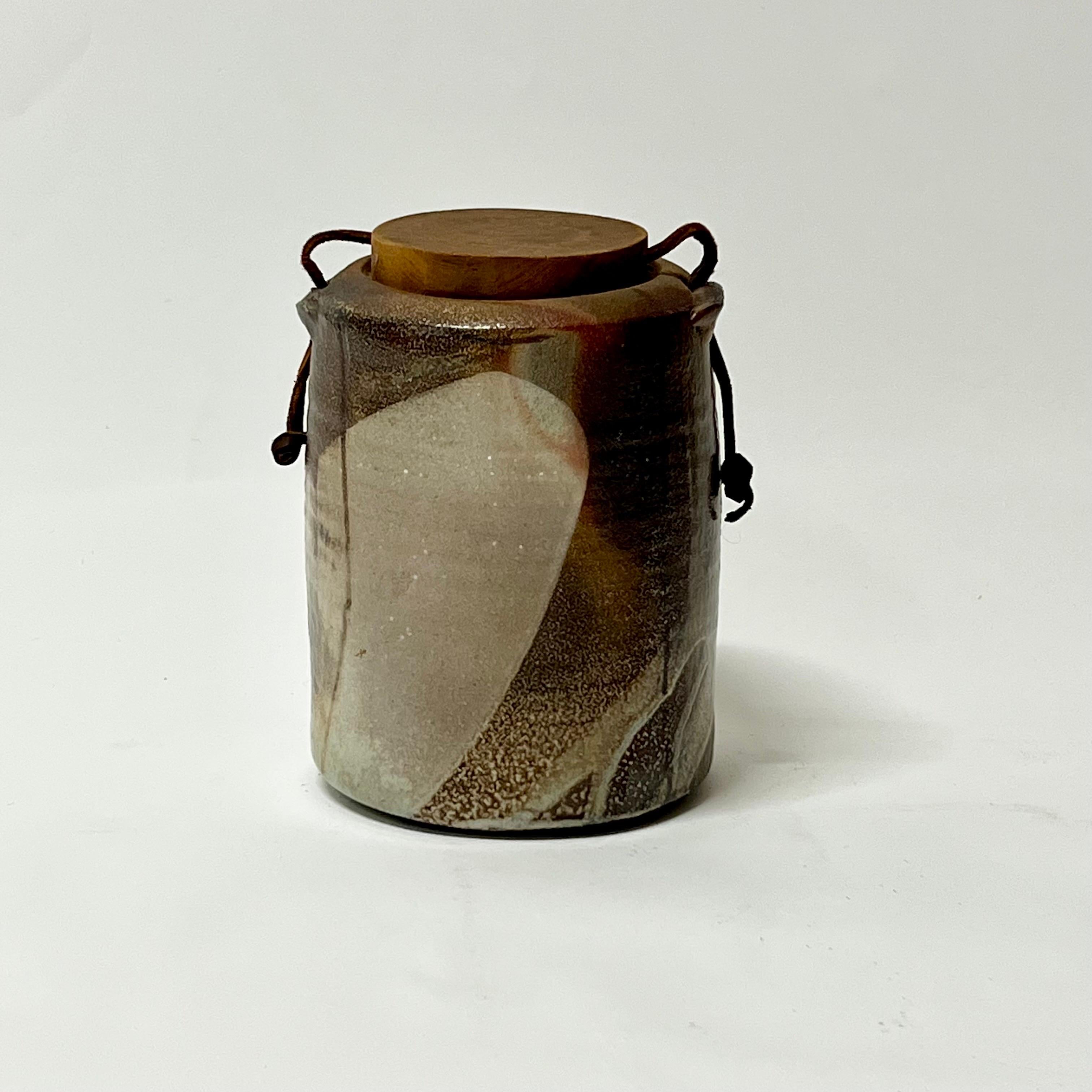 Amazing lidded cylinder vessel by well listed potter, Sandra Johnstone circa 1970s. Johnstone (1936-1991) studied with Peter Voulkos at UC Berkeley in the 1950s. In addition Johnstone also studied with Paul Soldner. She eventually went on to build