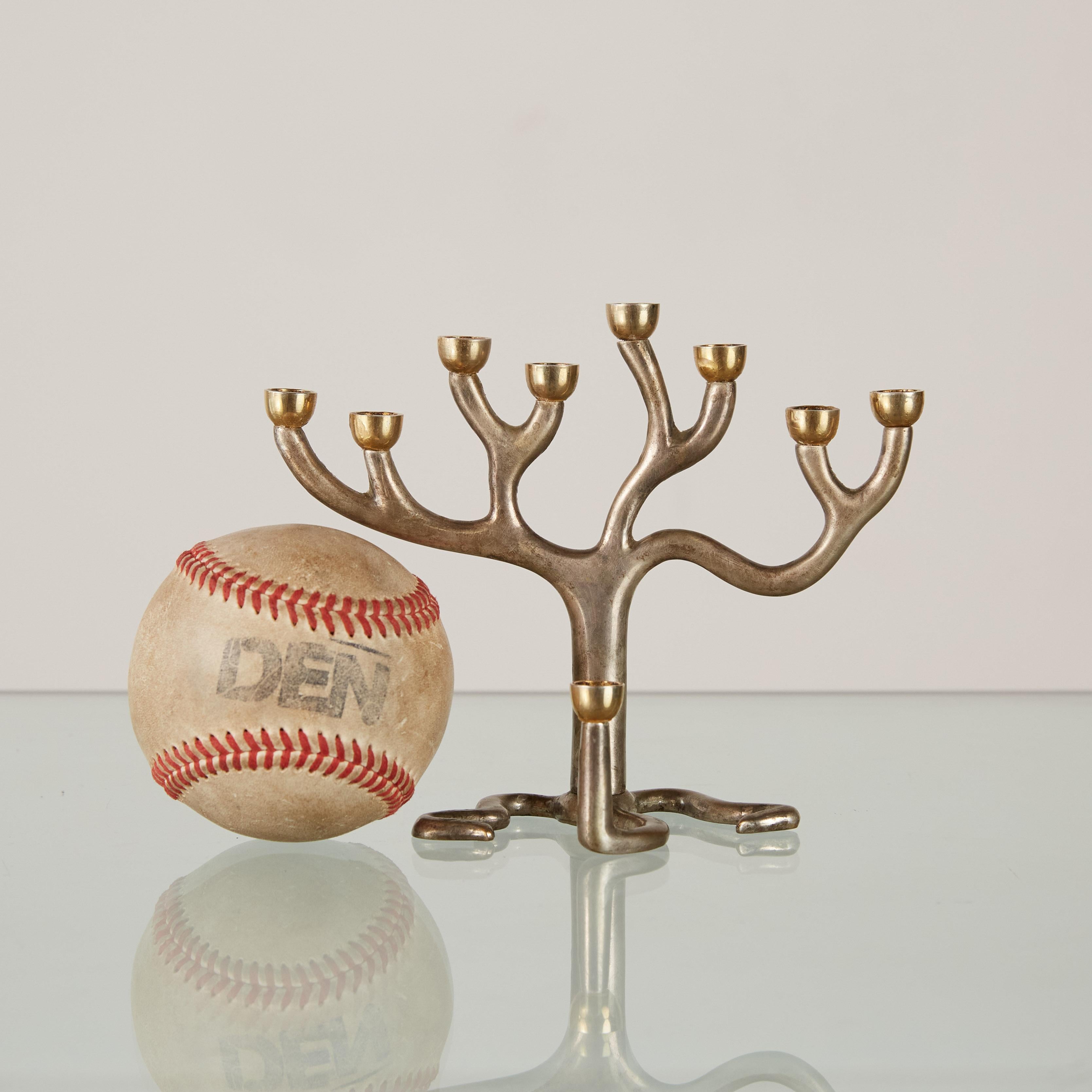Stunning Menorah designed by Sandra Kravitz for Germany-based Rosenthal specifically for the Judaica Collection. It is made of mixed metals - brass candleholders and a sterling silver base. The design references 