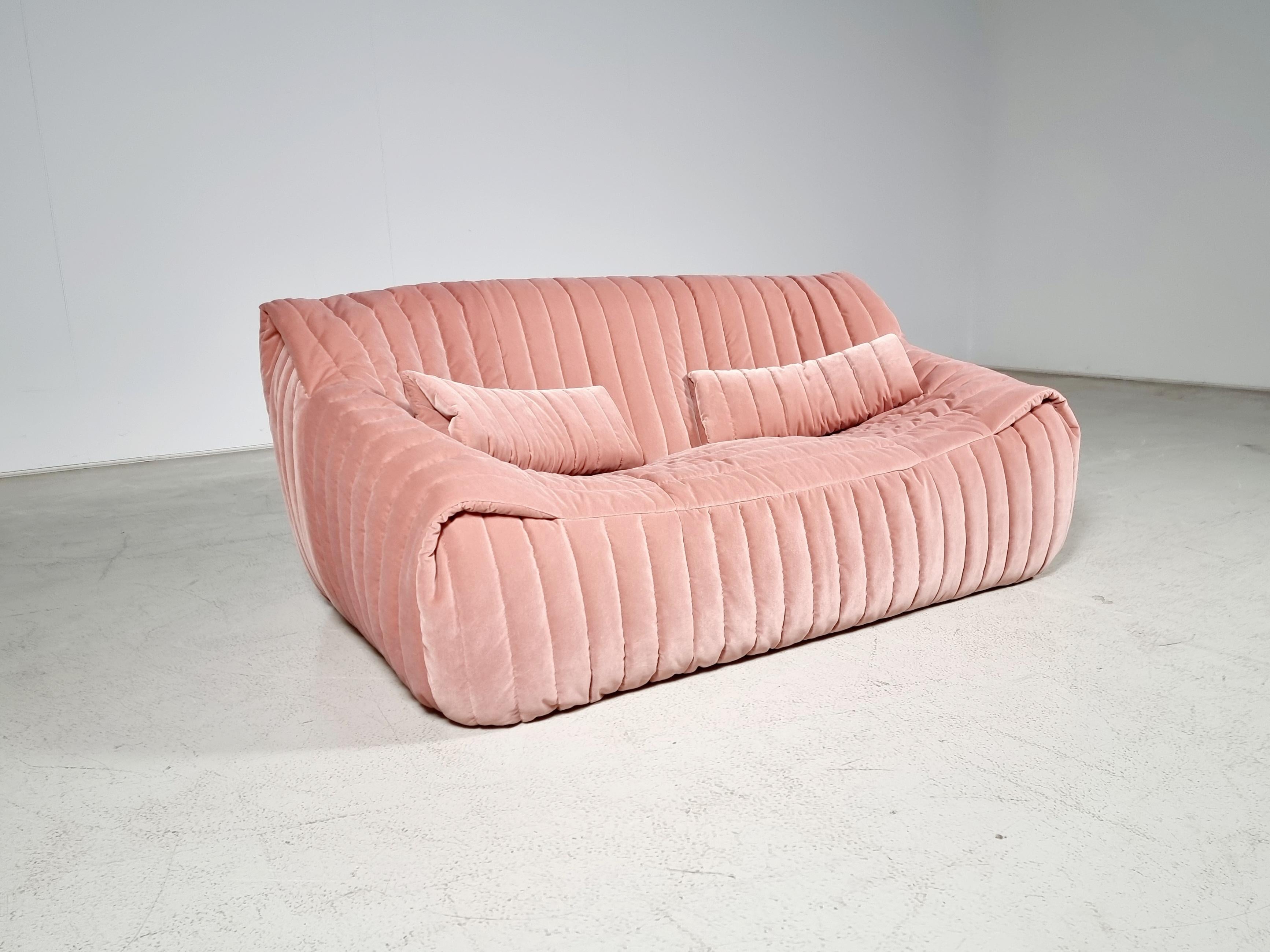 The Sandra sofa was designed by Annie Hiéronimus for Cinna after she joined the Roset Bureau d'Etudes in 1976.

Constructed fully from foam, the sofa has a solid form. Reupholstered in a blush pink velvet fabric. It's extremely comfortable. 

