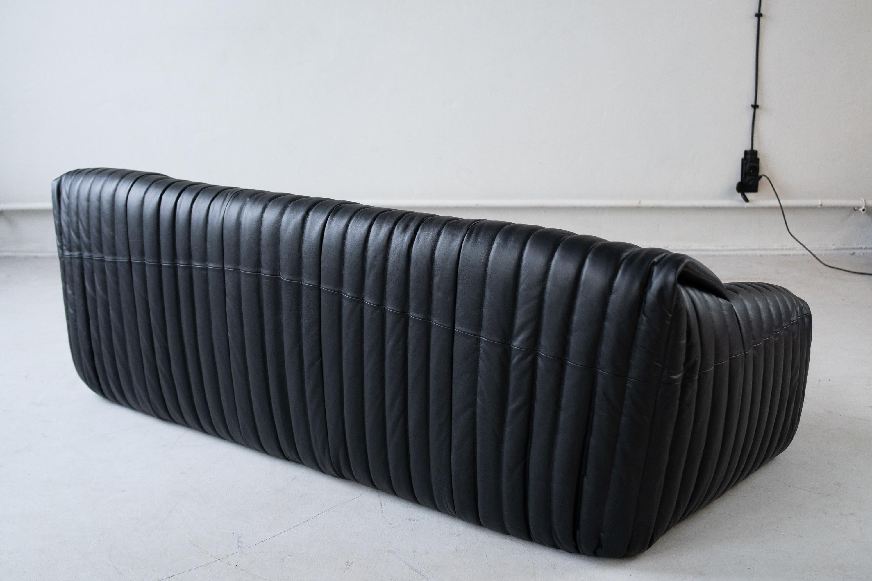  Sandra sofa  designed by Annie Hiéronimus for Cinna after she joined the Roset Bureau d’Etudes in 1976. 
Set of 3 seater , 1 seater and 1 seater. black leather upholstery.
 The inside of the sofa consists entirely of polyether foam and is,