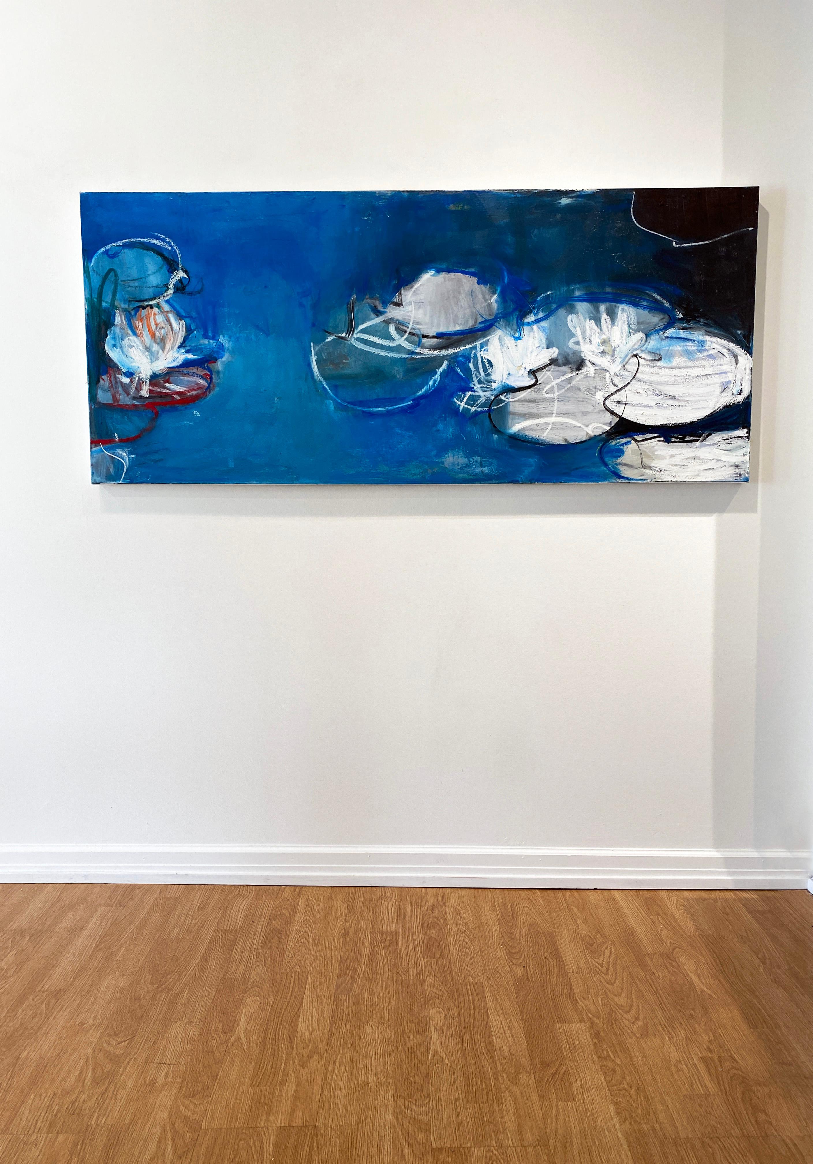 'Blue Water Lilies' by New York City based, French artist Sandrine Kern. 2021. Oil and cold wax on canvas, 30 x 70 in. This abstracted landscape painting features a pond and water lily scene in deep colors of blue, white, pink, red, and black.