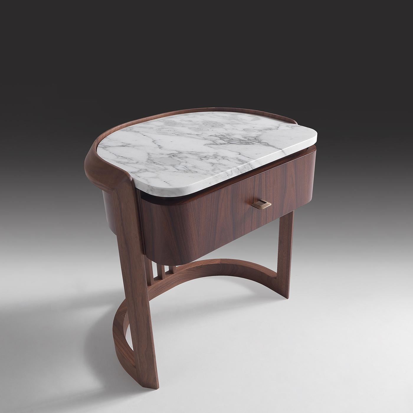 Clean and sophisticated as the signature features of Annibale Colombo's design, this splendid bedside table will make for an exceptional complement to a contemporary-style bedroom decor. Handcrafted of Canaletto walnut and rosewood, it displays a