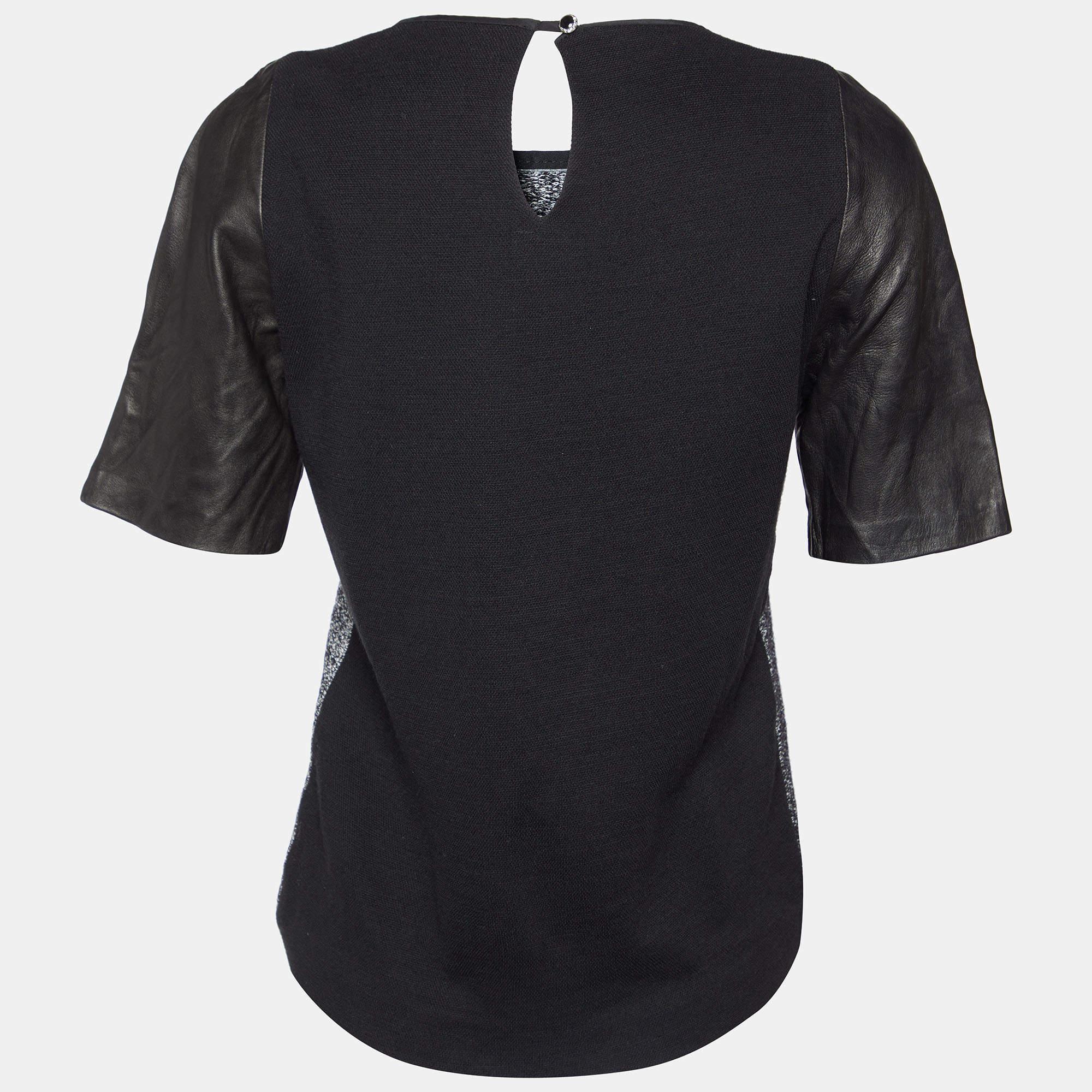 Indulge in sophistication with the Sandro blouse. Crafted with exquisite attention to detail this garment combines luxurious terry cloth with sleek leather accents creating a modern yet timeless piece. Effortlessly chic it seamlessly transitions