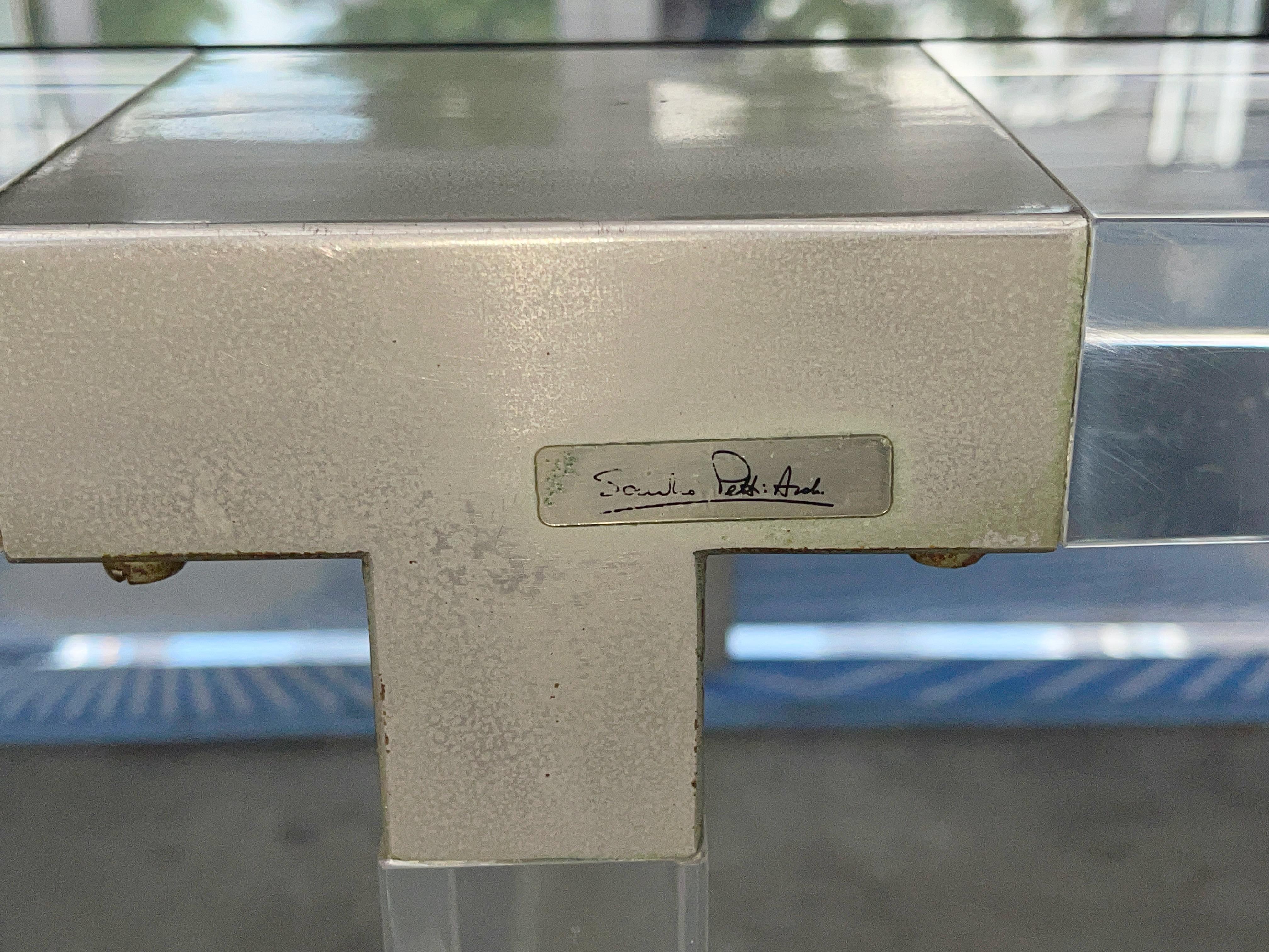 Sandro Petti, chrome mounted lucite coffee table for L'AngoloMetallArte, Roma. c. 1970s, Italy. 
Very thick acrylic. 
Four matte chrome steel connector brackets around top edge of table with Sandro Petti signed metal tag. 
Polished chrome connector