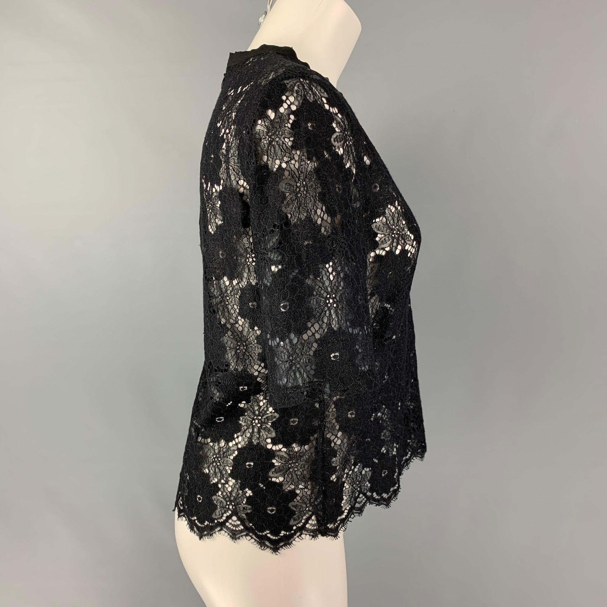 SANDRO PARIS short sleeve dress top comes in a black polyamide blend lace featuring a 3/4 invisible zip up closure at center back.Very Good Pre-Owned Condition. 

Marked:  2 

Measurements: 
 
Shoulder: 15.5 inches Bust: 38 inches Sleeve: 11 inches