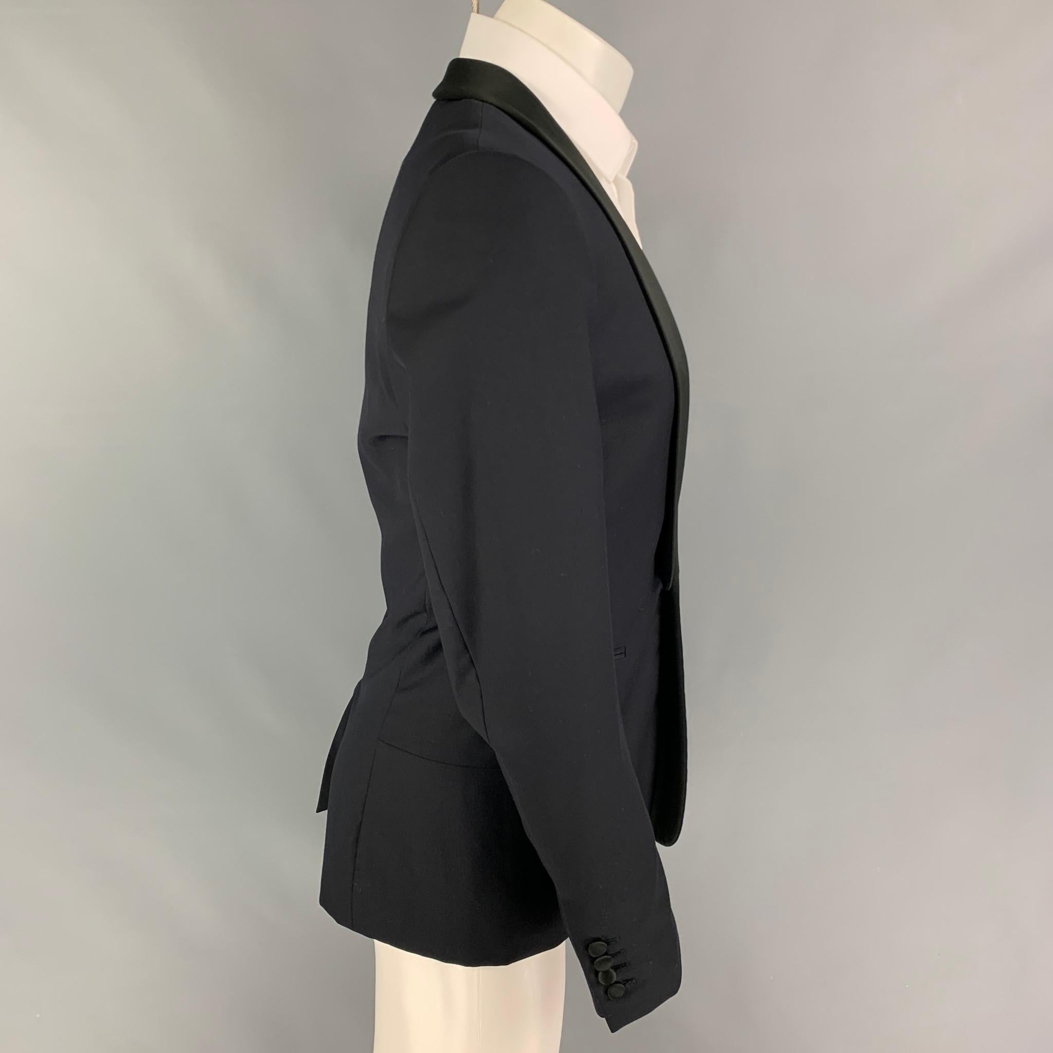 SANDRO sport coat comes in a black wool with a full liner featuring a shawl collar, slit pockets, single back vent, and a single button closure. 

Very Good Pre-Owned Condition.
Marked: 48

Measurements:

Shoulder: 17.5 in.
Chest: 38 in.
Sleeve: