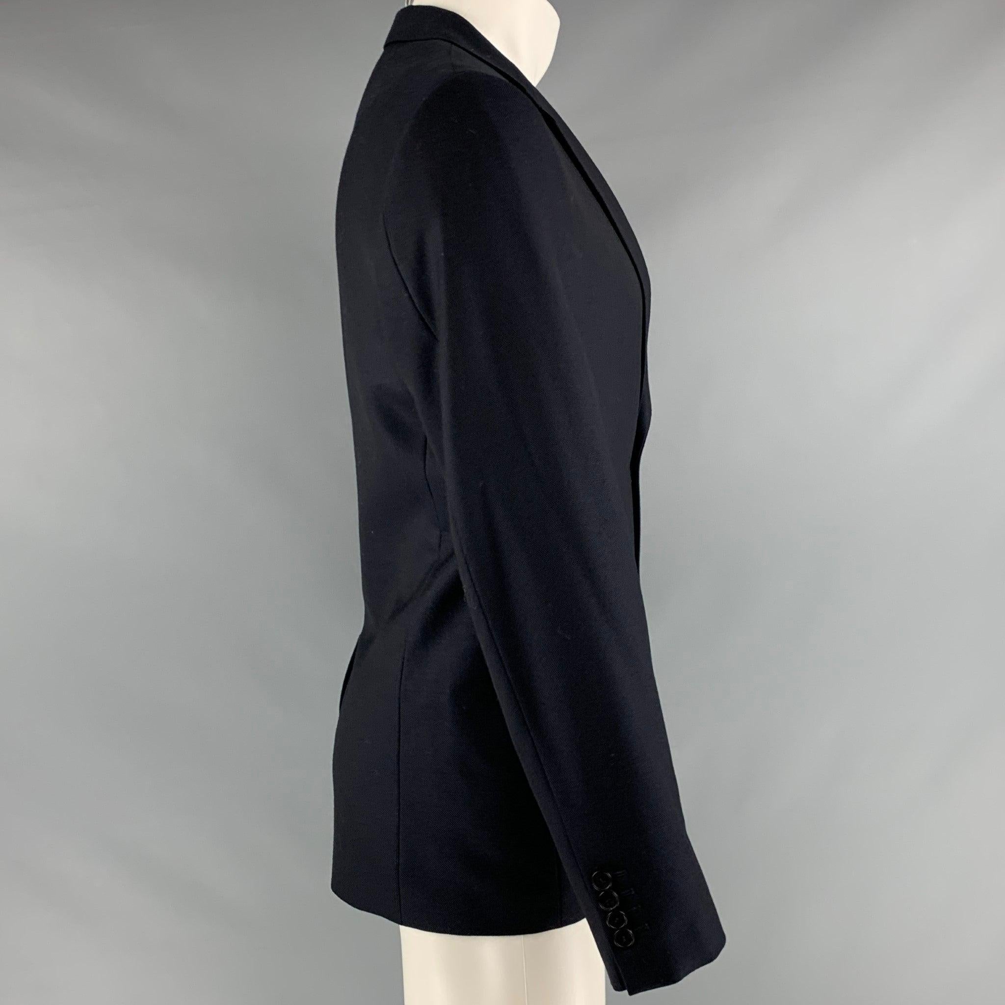 SANDRO sport coat in a
navy wool fabric featuring notch lapel, and two button closure.Excellent Pre-Owned Condition. 

Marked:   50 

Measurements: 
 
Shoulder: 18 inches Chest: 40 inches Sleeve: 26 inches Length: 28 inches 
  
  
 
Reference: