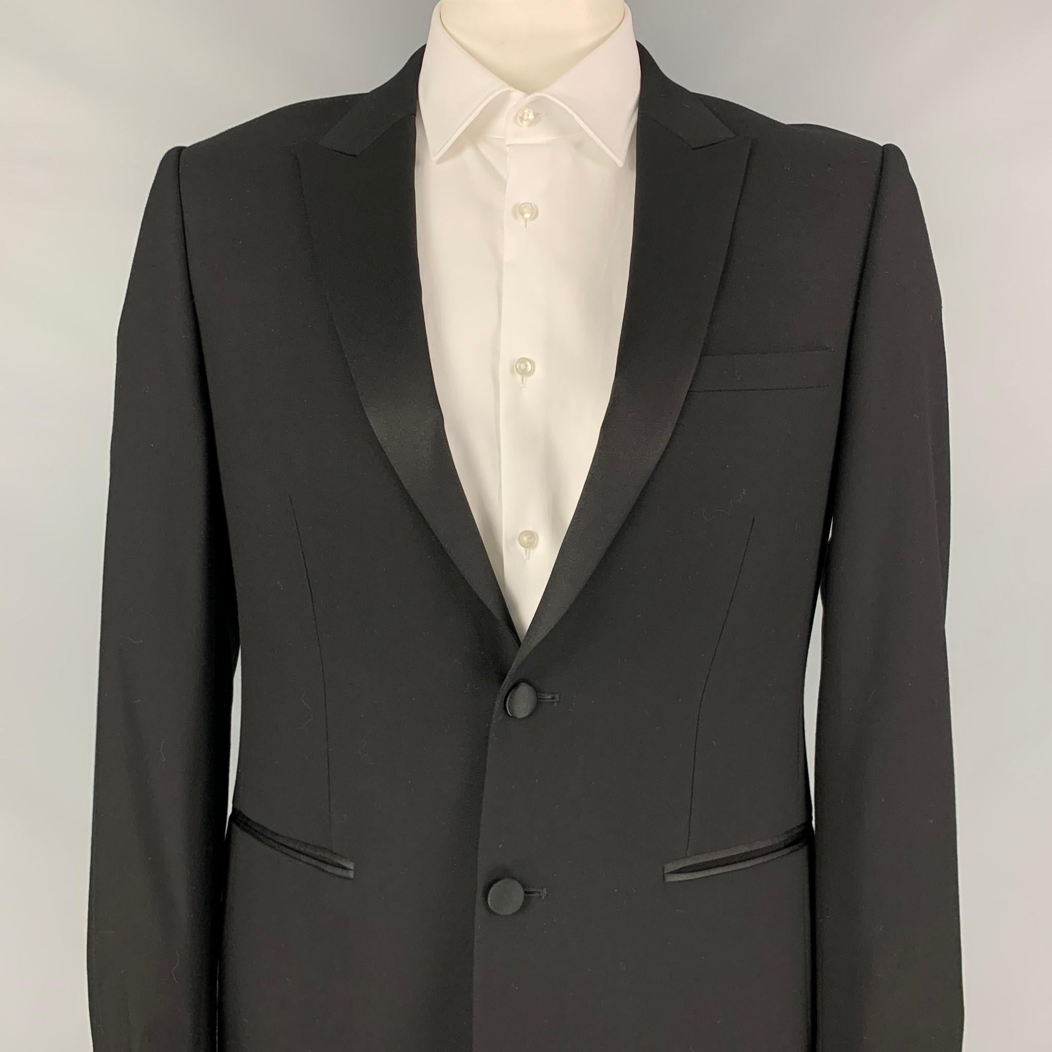 SANDRO sport coat comes in a black wool with a full liner featuring a peak lapel, slit pockets, single back vent, and a double button closure. 

Excellent Pre-Owned Condition.
Marked: 52

Measurements:

Shoulder: 18 in.
Chest: 42 in.
Sleeve: 27.5