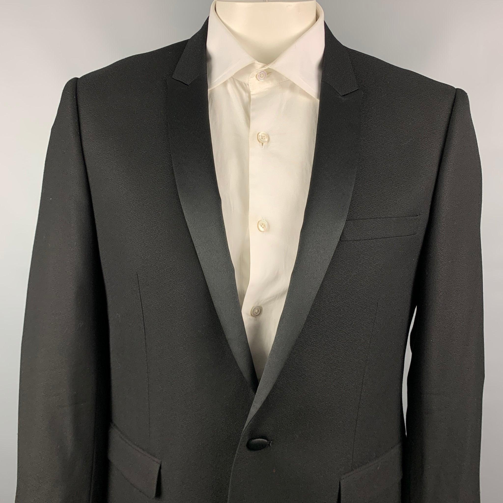 SANDRO sport coat comes in a black wool with a full liner featuring a peak lapel, flap pockets, and a single button closure. Very Good Pre-Owned Condition. 

Marked:   54 

Measurements: 
 
Shoulder: 18.5 inches  Chest: 44 inches  Sleeve: 26 inches 