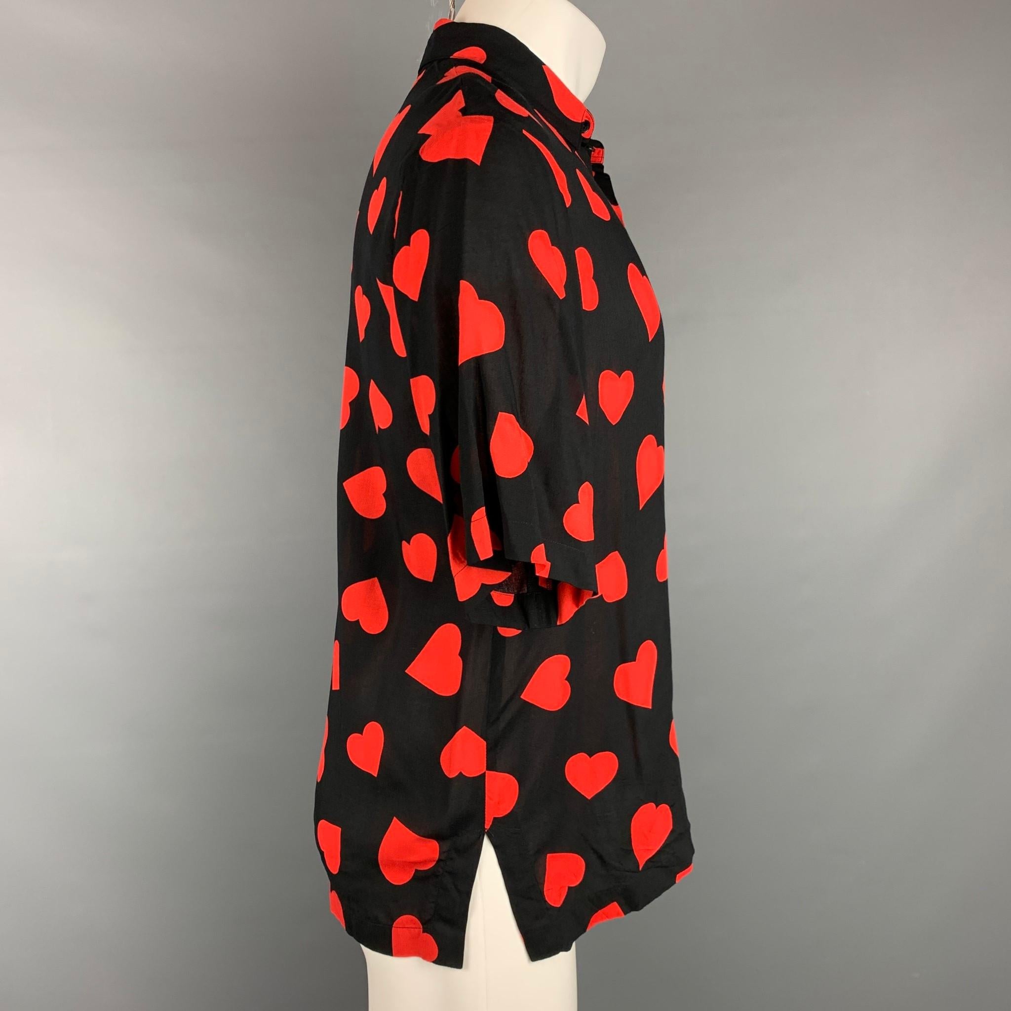 SANDRO short sleeve shirt comes in a red & black heart print viscose featuring a button up tsyle and a spread collar. 

Very Good Pre-Owned Condition.
Marked: L

Measurements:

Shoulder: 19 in.
Chest: 42 in.
Sleeve: 11.5 in.
Length: 27.5 in. 
