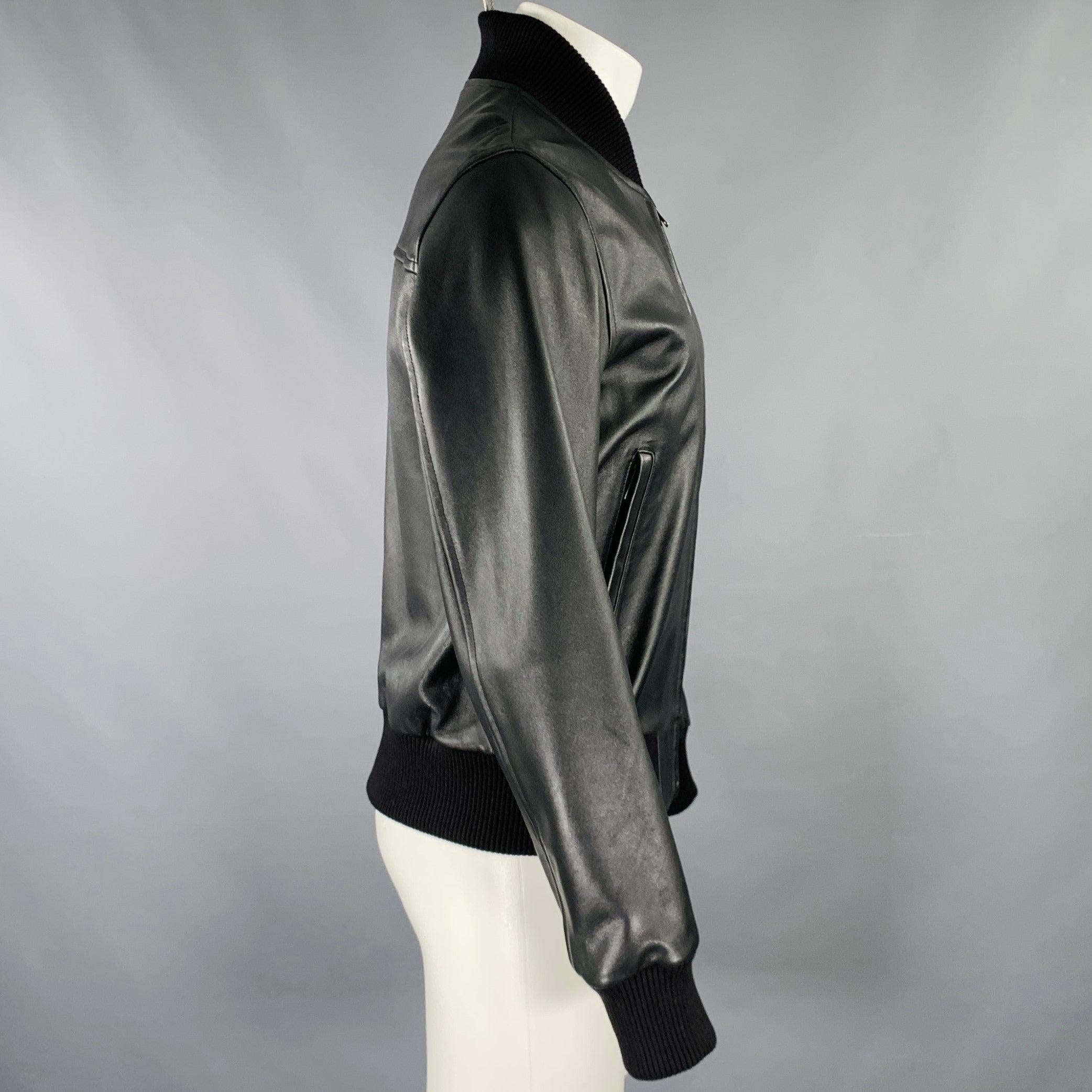 SANDRO jacket
in a black lambskin leather fabric featuring a bomber style, zip pockets, and zip up closure.Excellent Pre-Owned Condition. 

Marked:   M 

Measurements: 
 
Shoulder: 17.5 inches Chest: 40 inches Sleeve: 26.5 inches Length: 24 inches 
