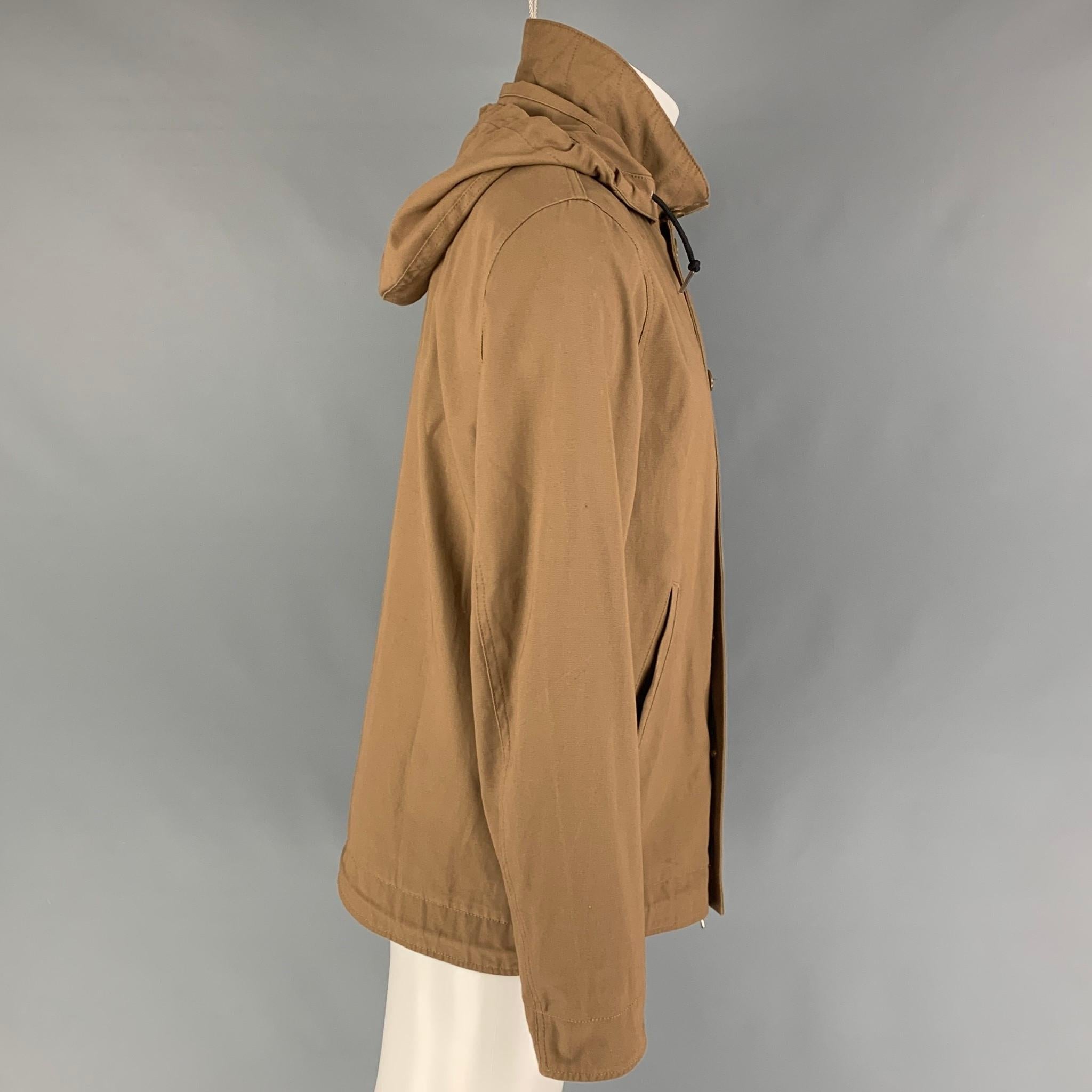 SANDRO jacket comes in a tan cotton featuring a detachable hooded style, slit pockets, drawstring, and a zip & buttoned closure. 

Very Good Pre-Owned Condition.
Marked: S

Measurements:

Shoulder: 18 in.
Chest: 42 in.
Sleeve: 26 in.
Length: 28 in. 