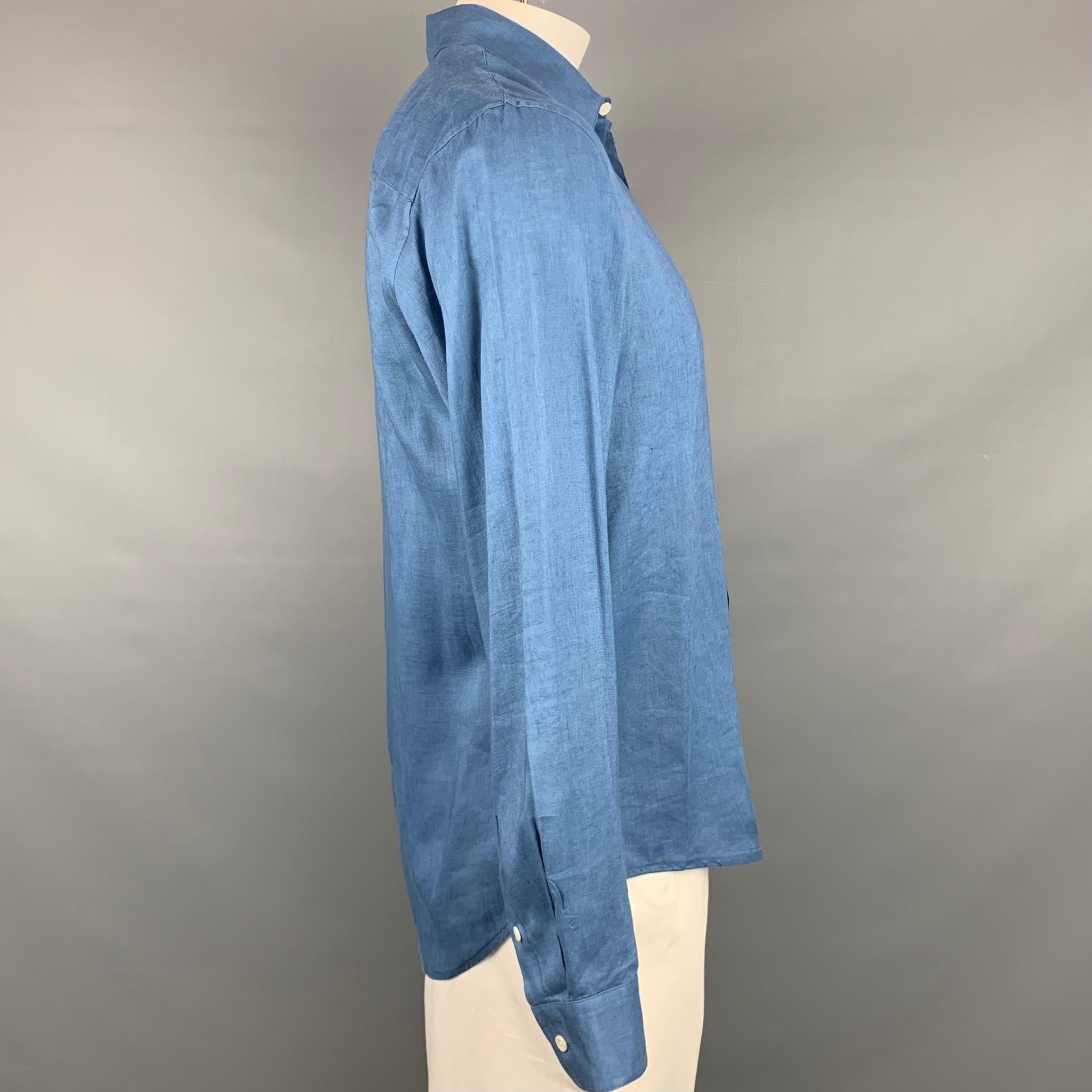 SANDRO long sleeve shirt comes in a blue linen featuring a classic fit, button up, and a spread collar. 

Very Good Pre-Owned Condition.
Marked: XL
Original Retail Price: $220.00

Measurements:

Shoulder: 19 in.
Chest: 44 in.
Sleeve: 26.5