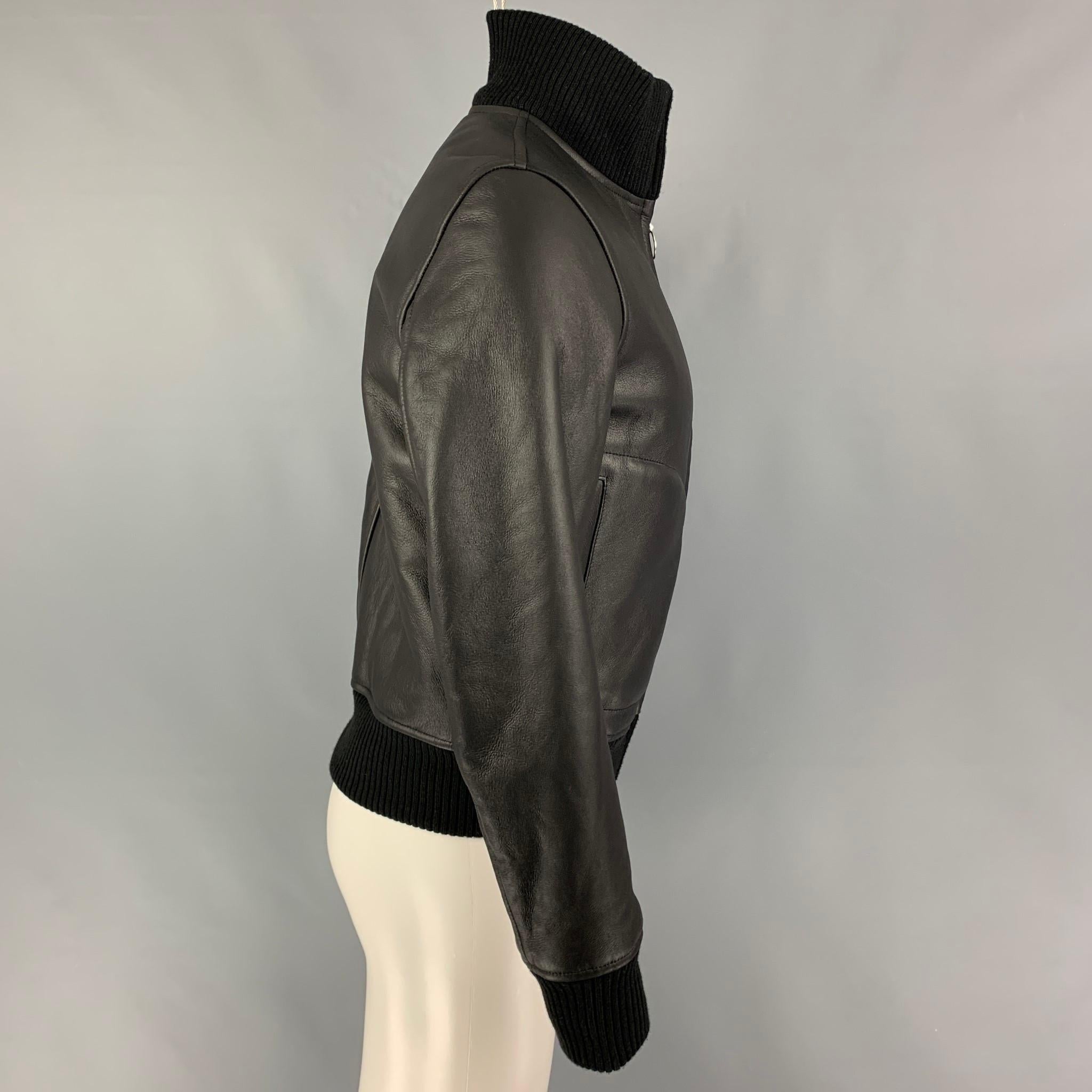 SANDRO jacket comes in a black leather featuring a bomber style, high collar, ribbed hem, zipper pockets, and a full zip up closure. 

Excellent Pre-Owned Condition.
Marked: XS
Original Retail Price: $1,890.00

Measurements:

Shoulder: 18 in.
Chest: