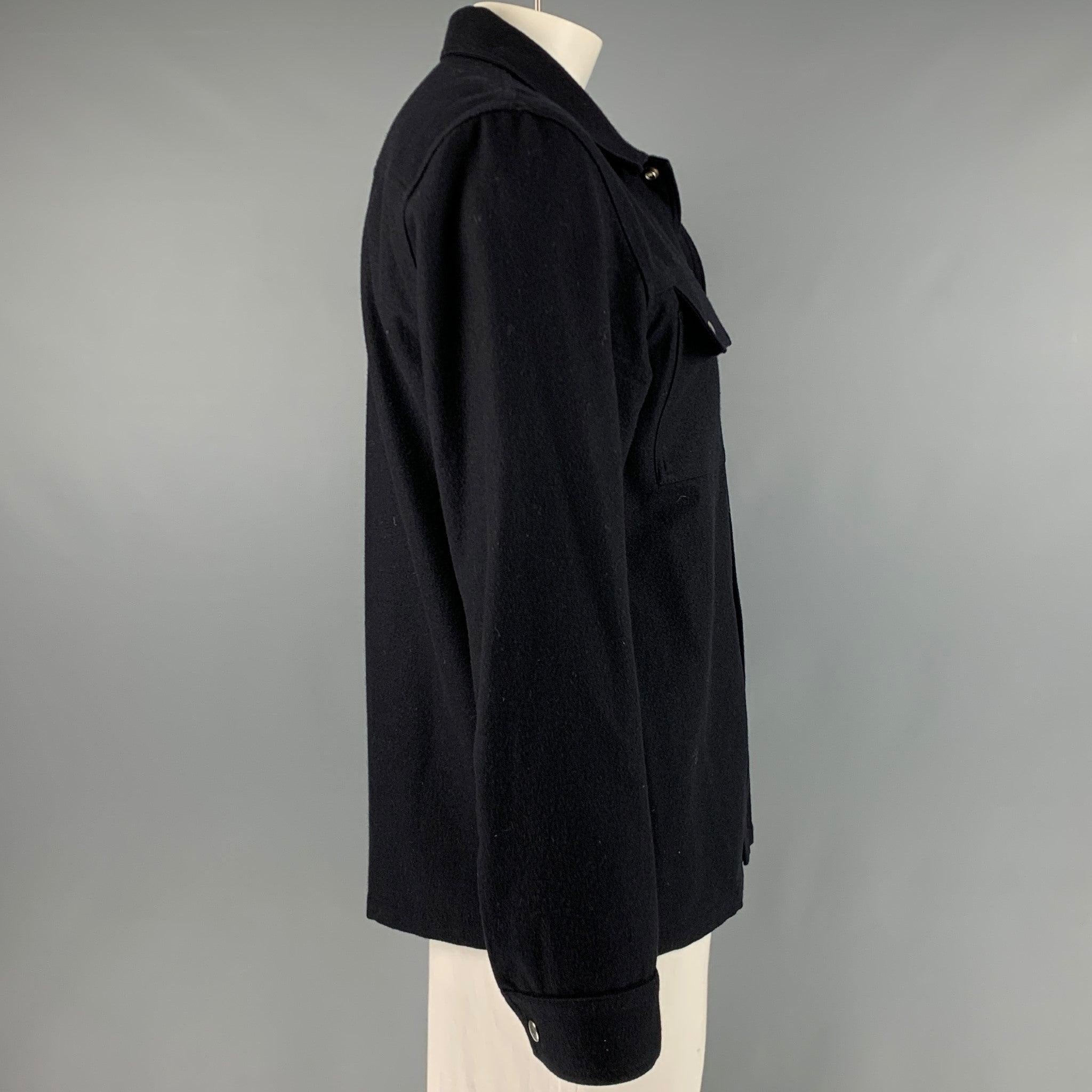 SANDRO long sleeve shirt
in a black wool blend fabric featuring two patch pockets, spread collar, and snap closure.Excellent Pre-Owned Condition. 

Marked:   XXL 

Measurements: 
 
Shoulder: 20 inches Chest: 45 inches Sleeve: 26 inches Length: 29