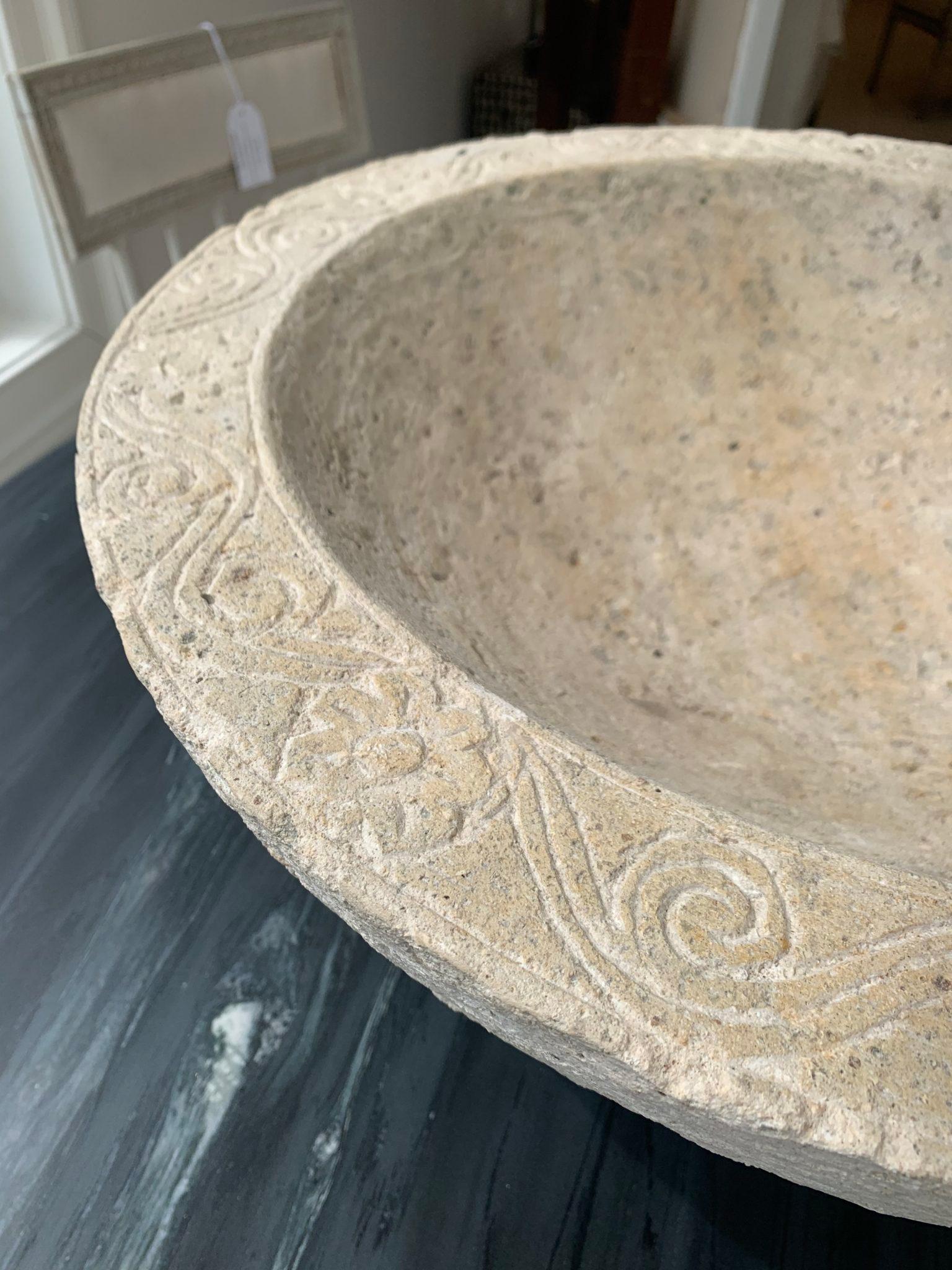 Large, very heavy limestone bowl with carving on the top rim.