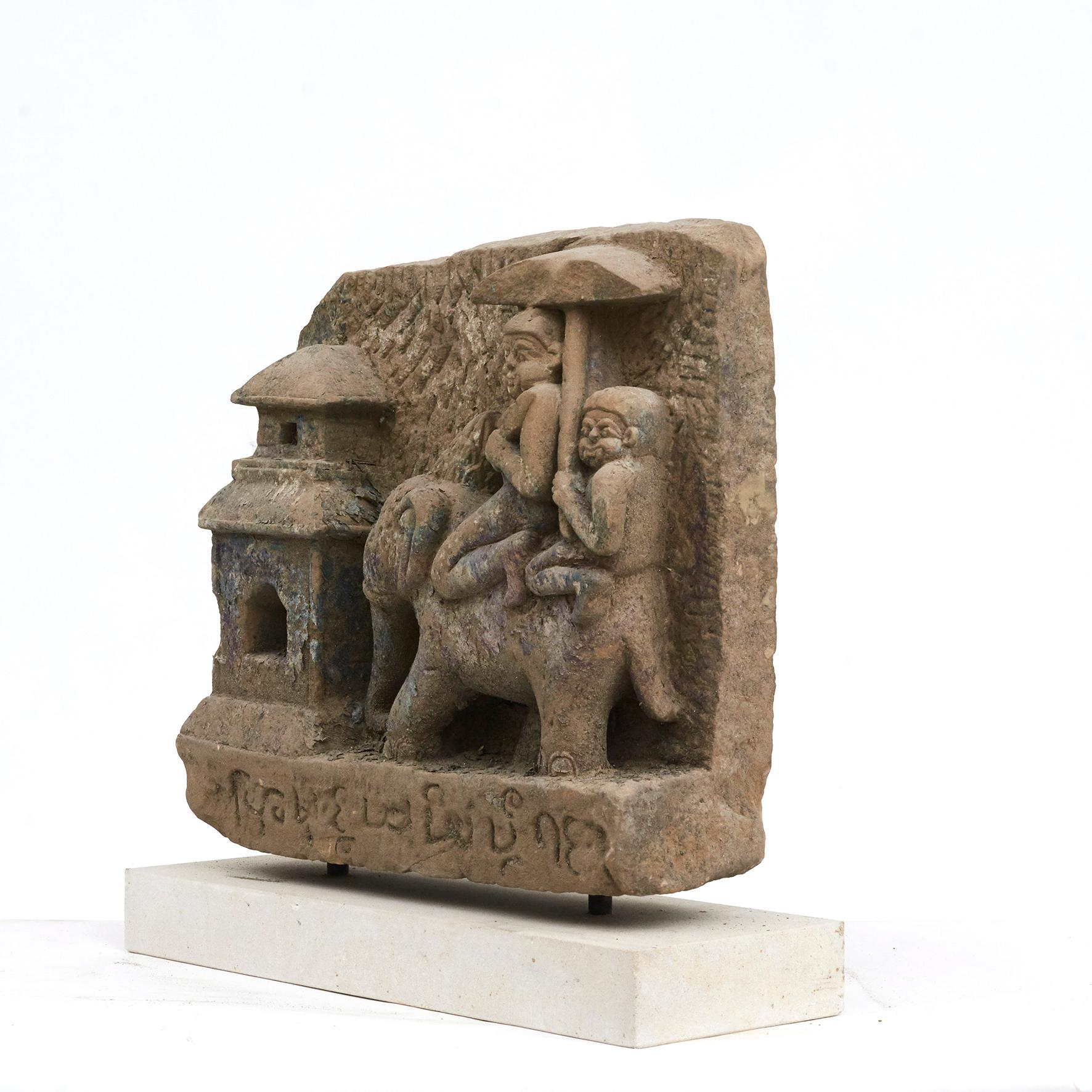 500-600 Year old sandstone carving.
The sculpture is depicting 'Two demons riding an elephant at the pagoda'. 
From Buddha pagoda / temple in Arakan, Burma.

Naive and charming in its design. With a beautiful patina. Mounted on light sandstone