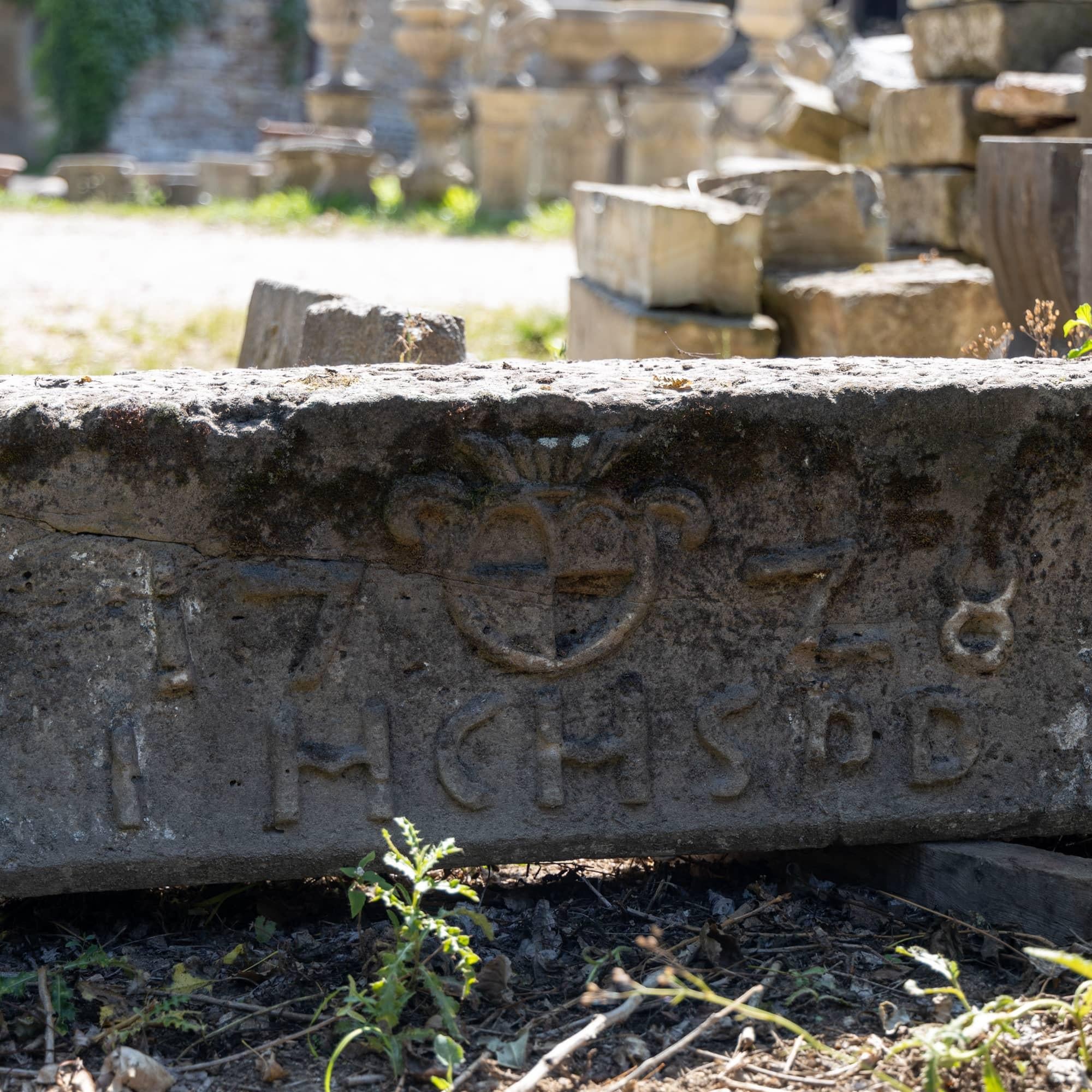 Large lintel of a portal made of sandstone. The stone block is dated 1778 with a central coat of arms and comes from the deconstruction of a house in Franconia.