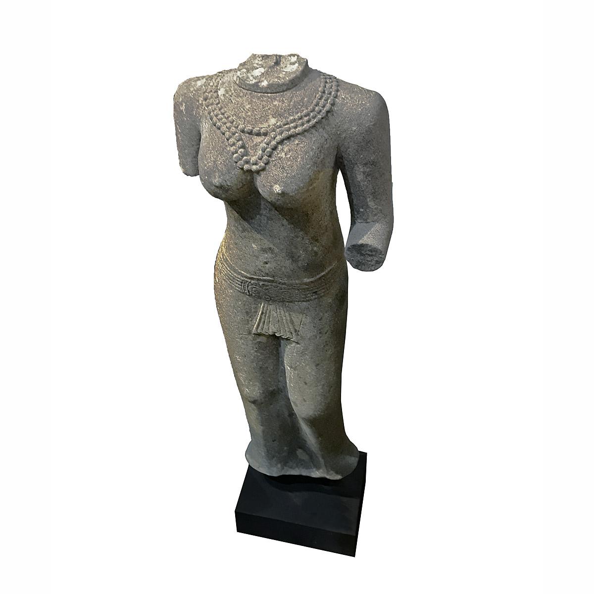 A hand-carved sandstone torso of woman, inspired on the traditional decorations of Thai ancient temples. At 47 inches high, it stands as an attractive outdoor element, or as an indoor eye-catching accessory  

Mounted on a black wood and metal base. 