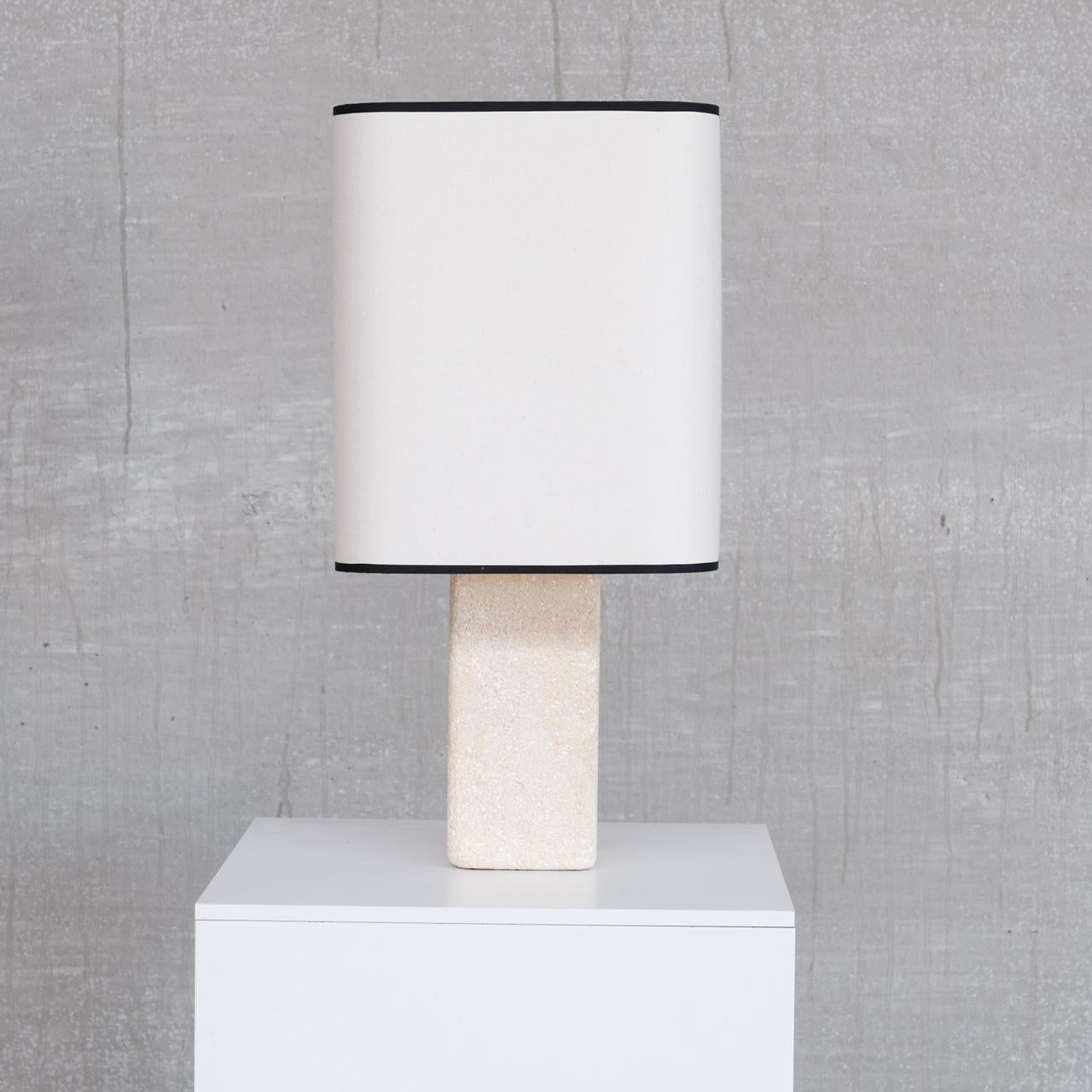 A sandstone table lamp. 

Belgium, c1960s. 

New hand made shade custom made for the lamp which emulates the curves. 

Since re-wired and PAT tested. 

Location: Belgium Gallery. 

Dimensions: 61 H x 30 W x 30 D, the Base is 12 W x 12 D in