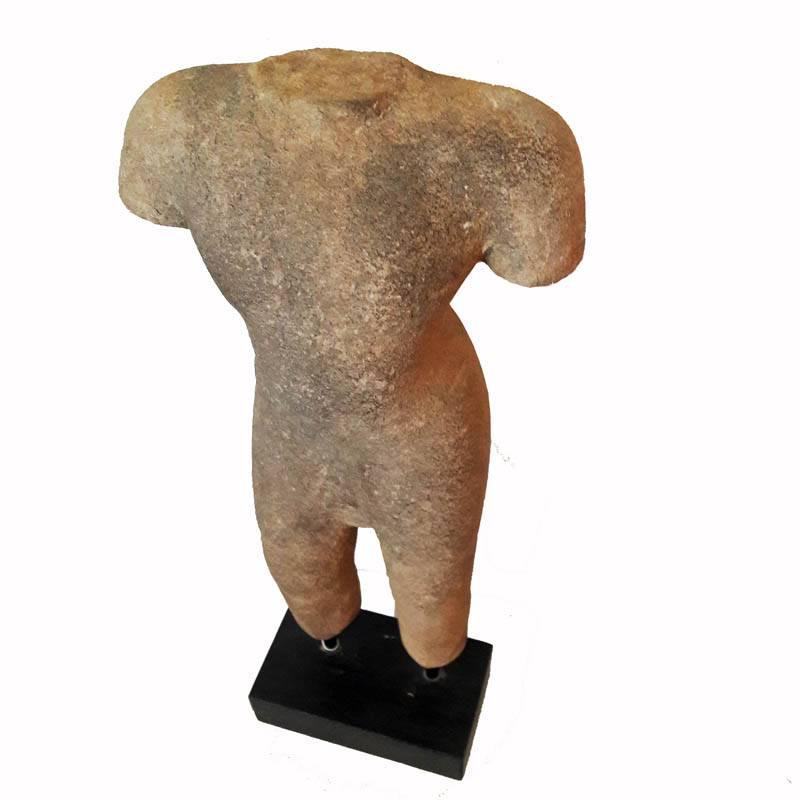 A sandstone hand-carved male torso from Thailand, late 20th century. Mounted on a black wood stand.