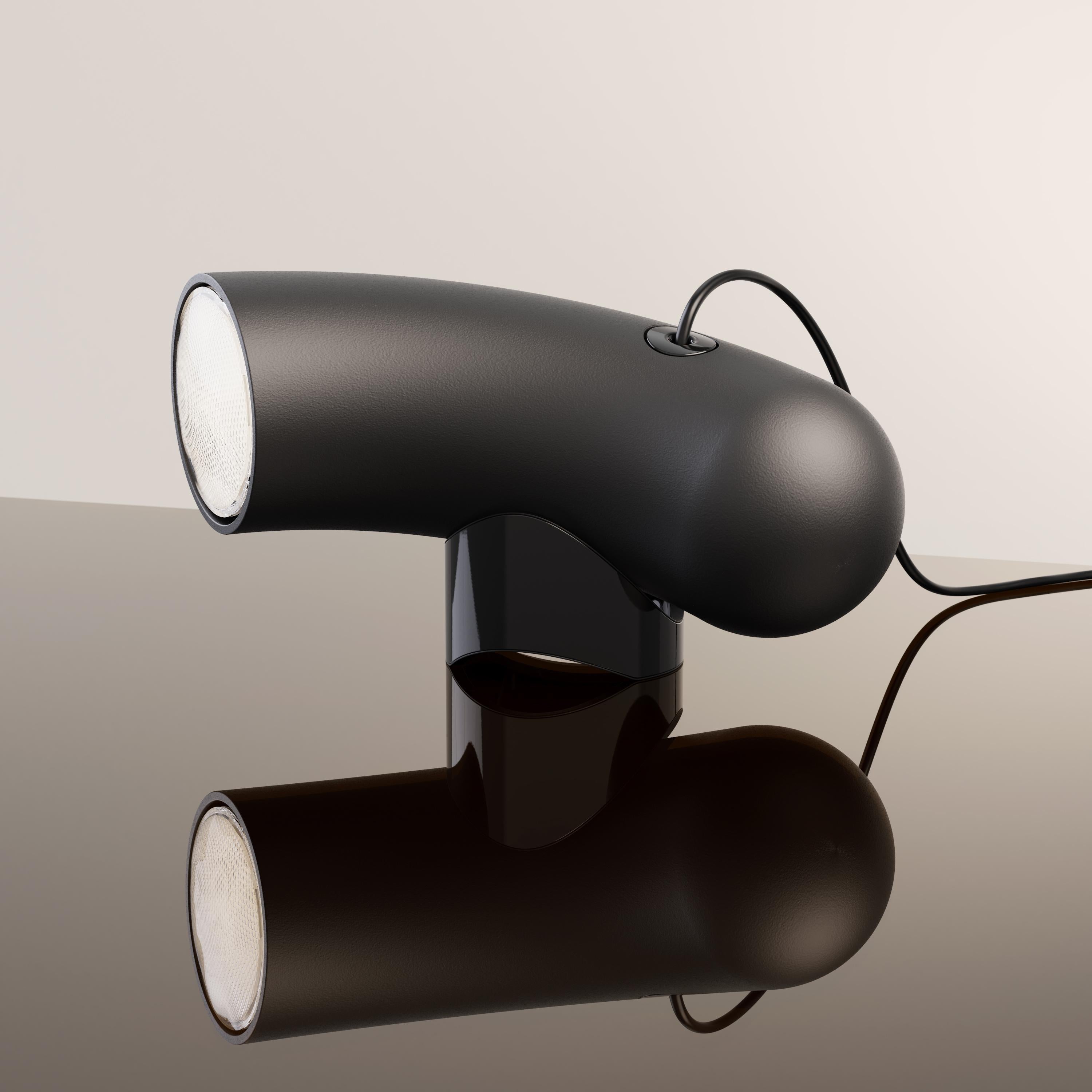 Sandy black Hyphen Simple table lamp by Studio d'Armes
Dimensions: D 11 x W 32 x H 15 cm
Materials: Sanded black cast steel.
Available in steel sandy black, steel chromatic black, natural porcelain and steel custom.

Derived from the ancient